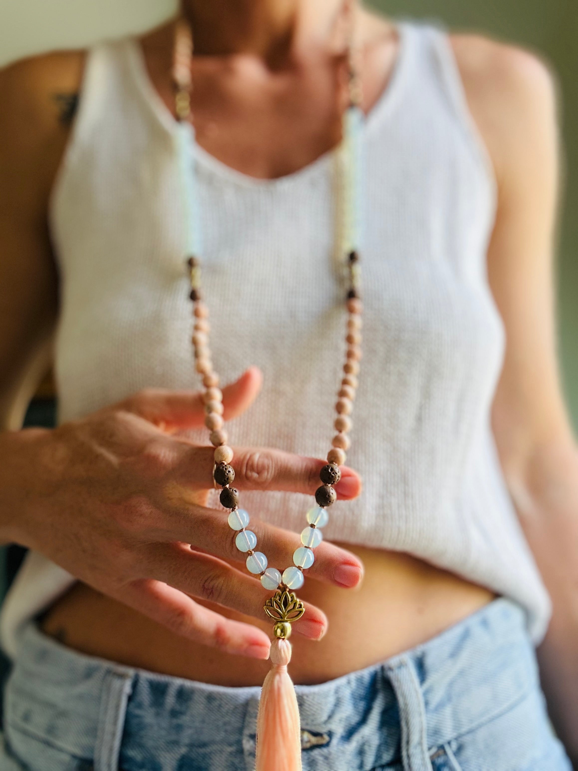 Wearing the Goddess Powerhouse Mala fosters spiritual awakening with Opalite and grounding energy with Lava, offering tranquility