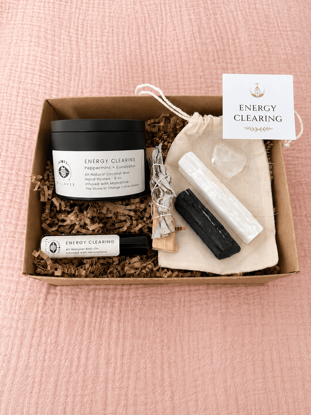 BellaVee Full Size Energy Clearing Ritual Kit featuring an Energy Clearing crystal candle, perfume oil, selenite tower, black tourmaline, clear quartz, palo santo, white sage, and a ritual card.