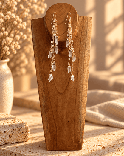 Five-stone Clear Quartz crystal drop earrings with cascading gold chains on wooden form