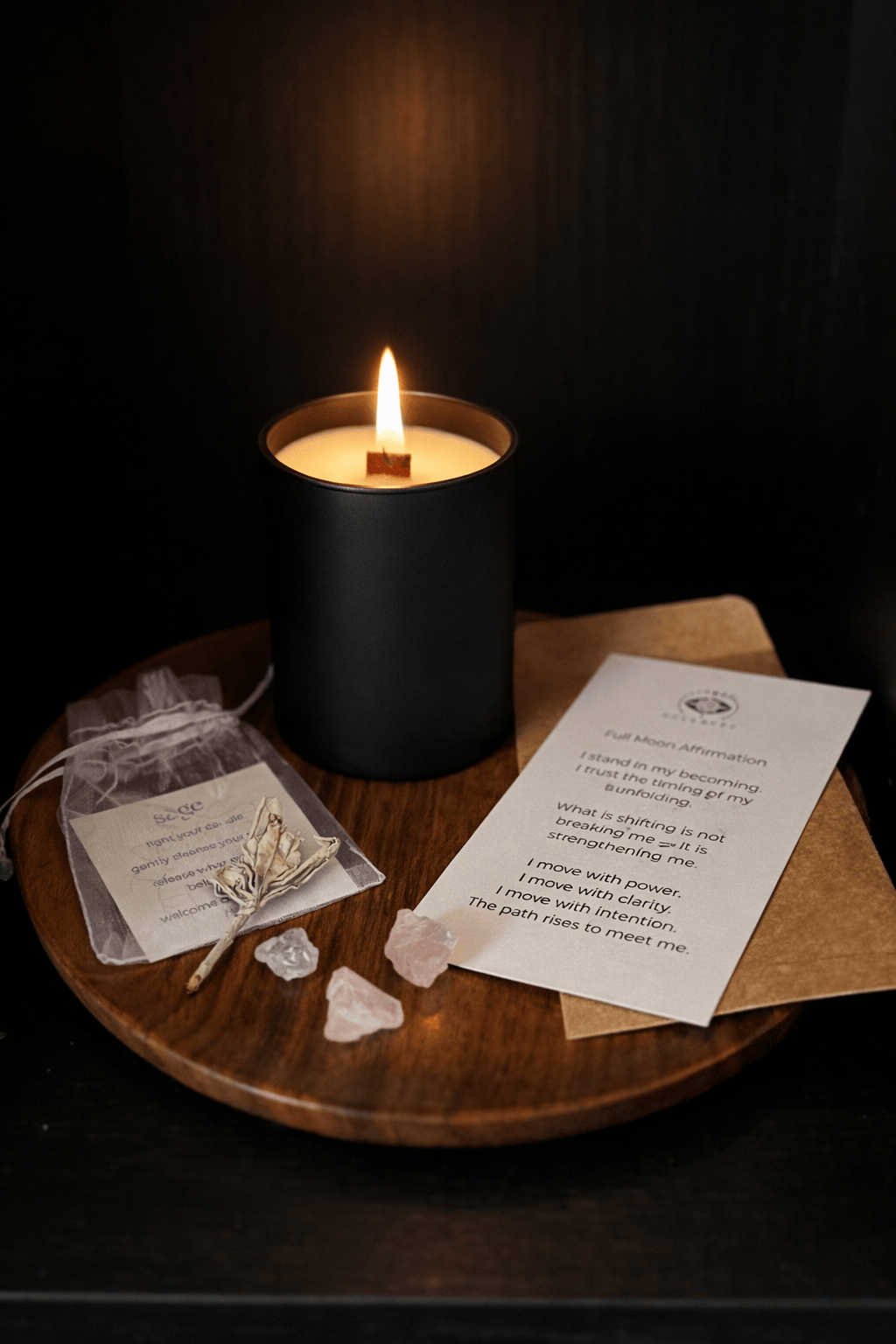 Candle burning on a wooden surface with ritualistic items and a piece of paper.