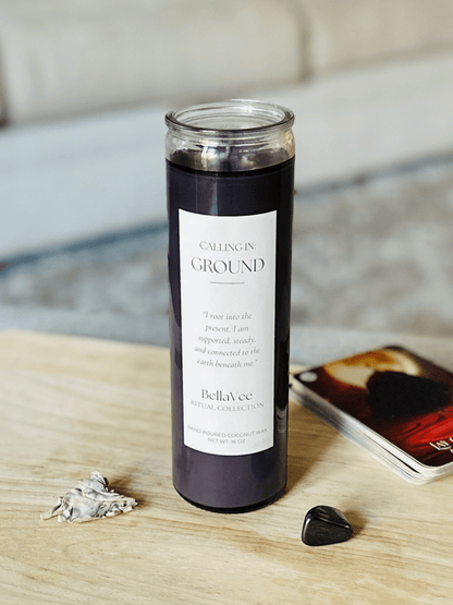 Calling In: Ground Candle on a wooden surface with black grounding crystal and cozy background