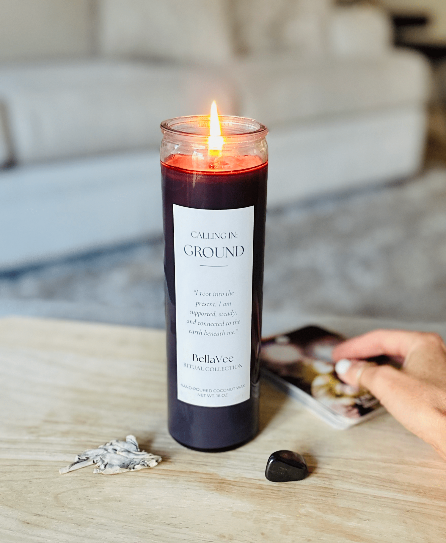 Deep mocha candle lit in a serene space, representing grounding and stability