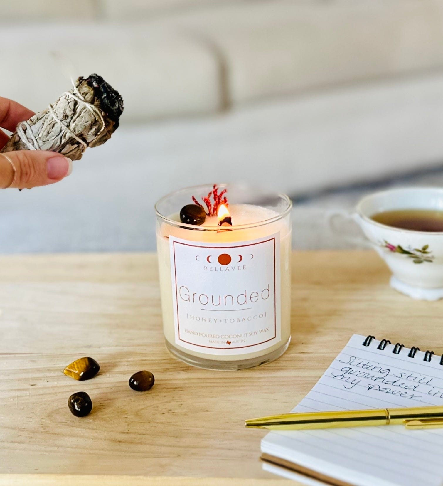 Lit Grounded Tiger's Eye crystal candle with sage cleansing the candle