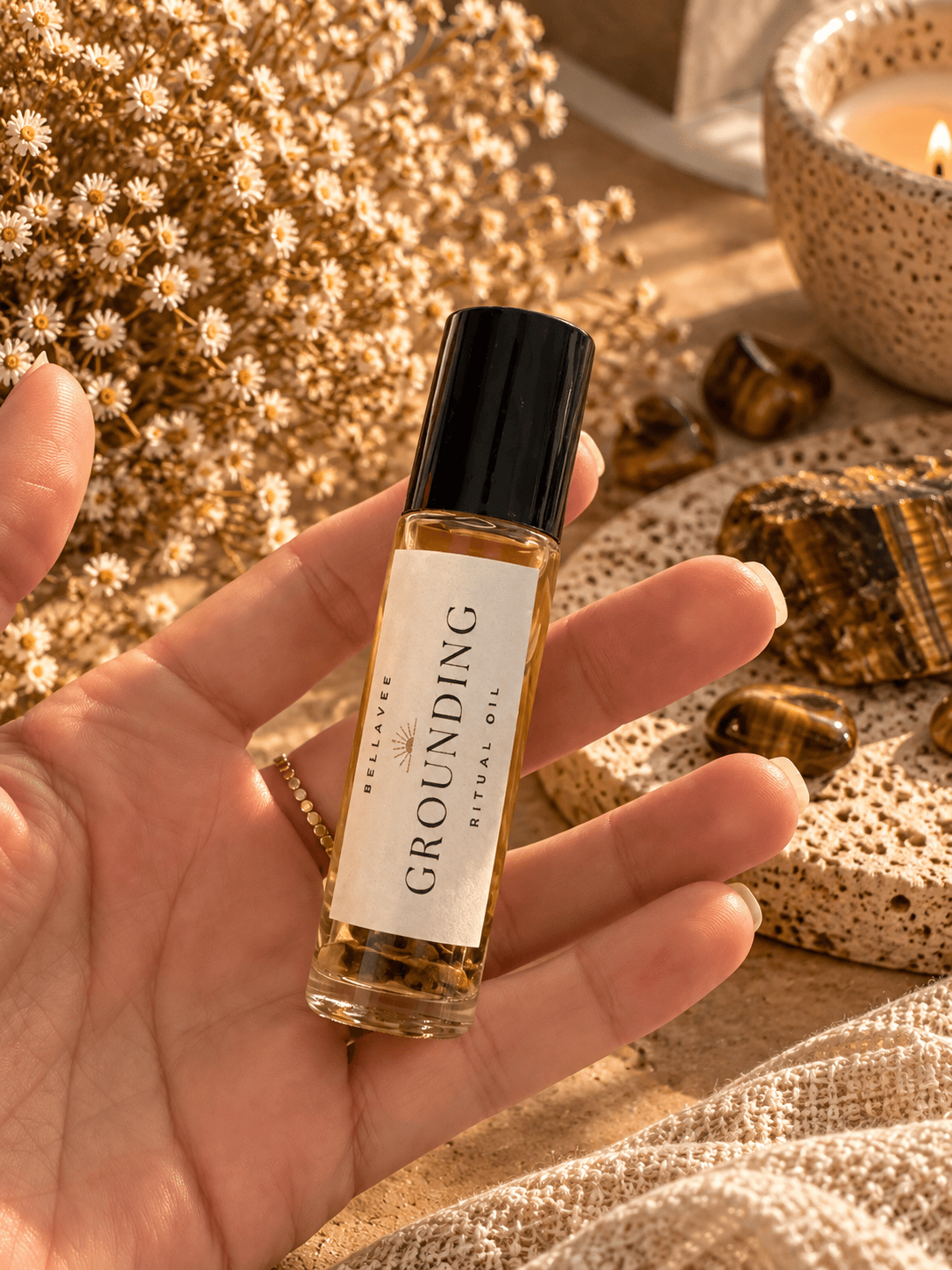 Close-up of a woman holding BellaVee GROUNDING Ritual Oil roll-on with Tiger&