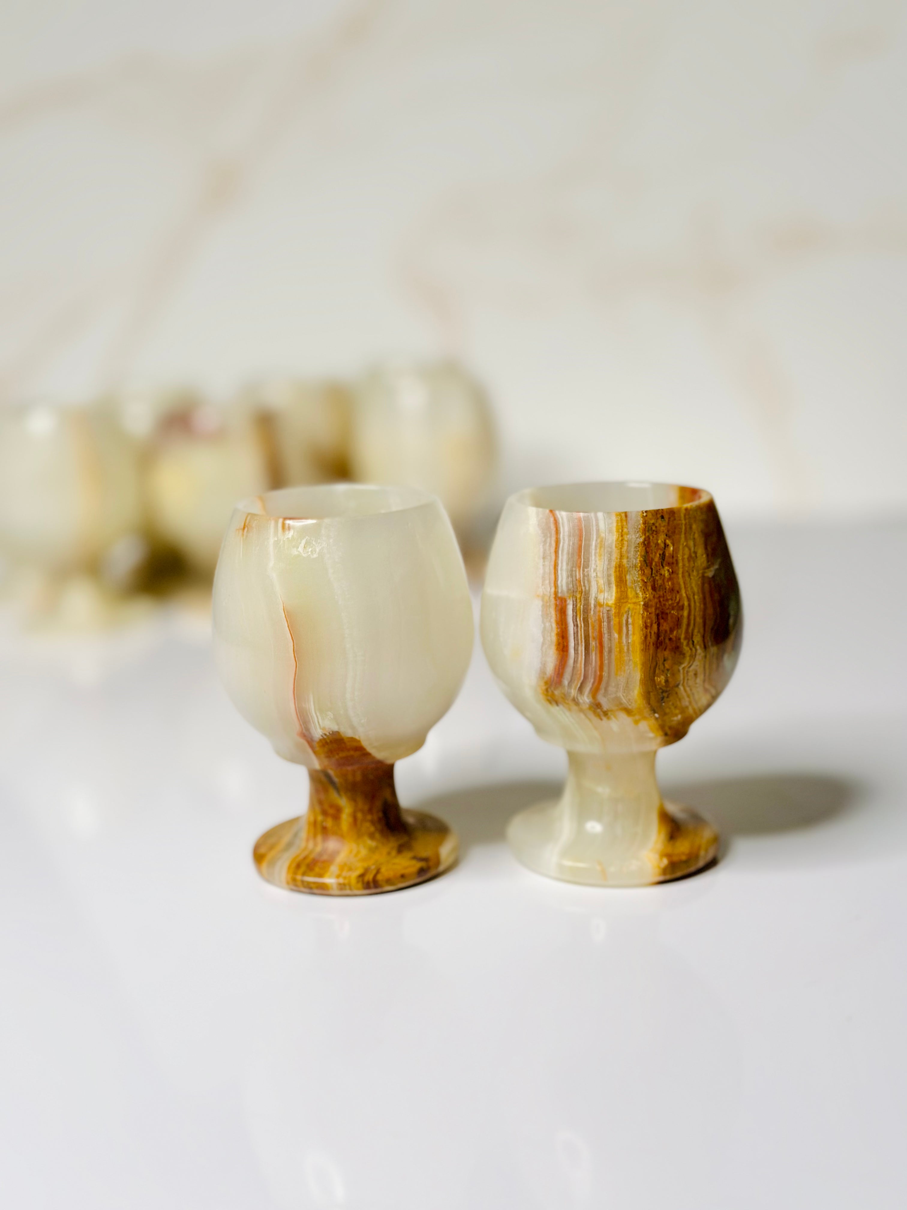 Each Onyx shot glass in this set of two is a unique piece of art, with natural stone variations adding to its charm and elegance