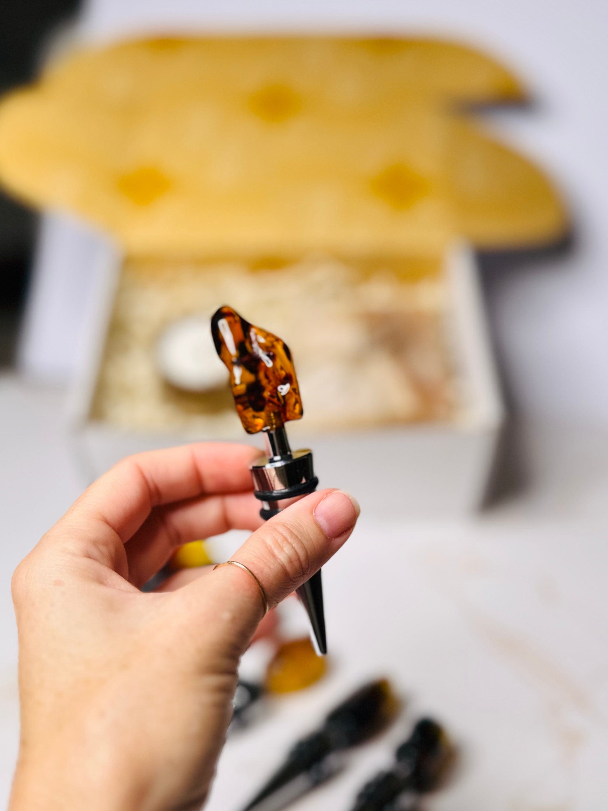 Handcrafted wine stopper with amber detail, perfect for preserving bottles and enhancing decor.