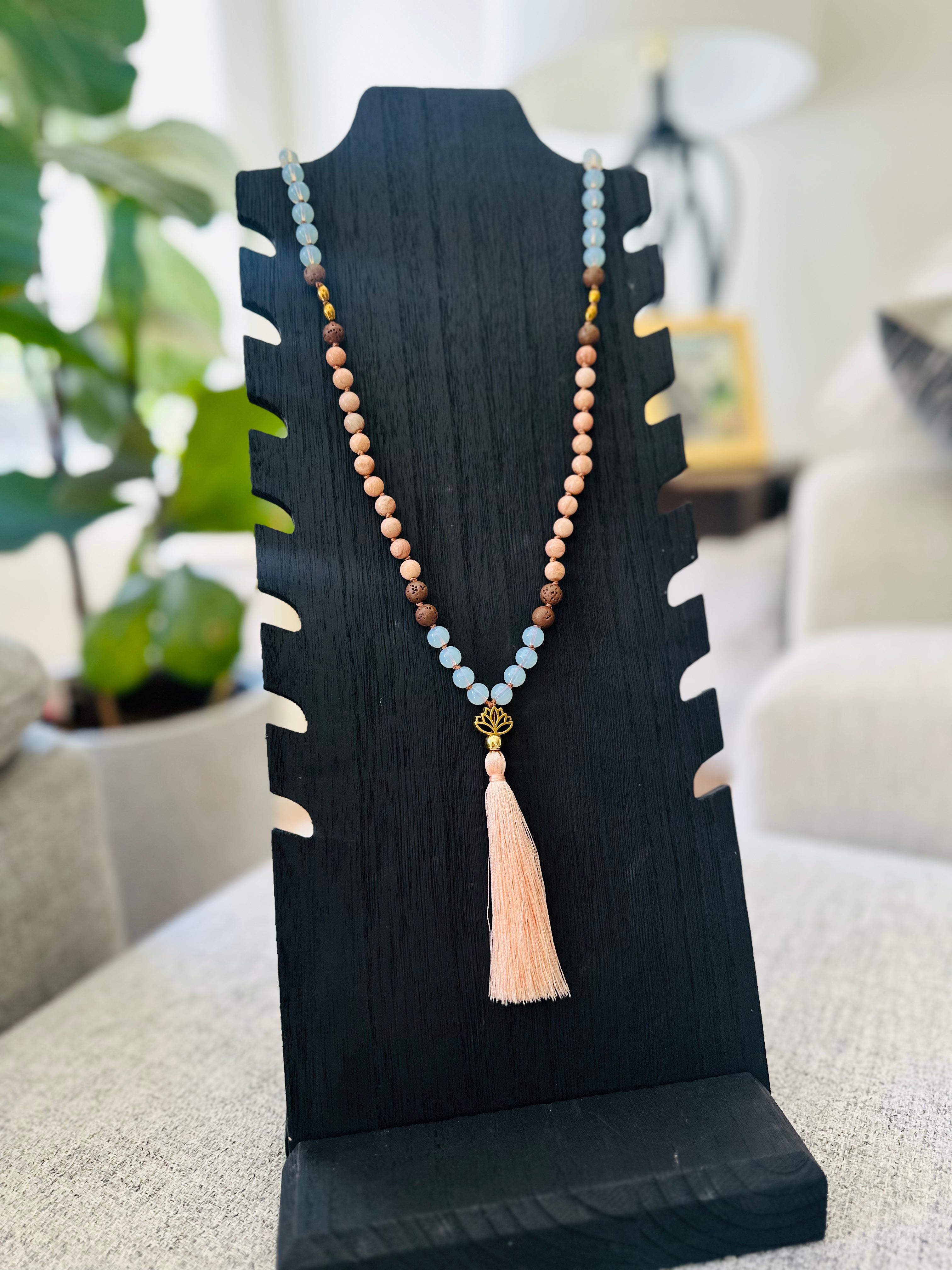 Crafted with Lava, Opalite, Peach Moonstone, and Hematite, the Inner Harmony Mala helps balance emotions and encourages inner peace