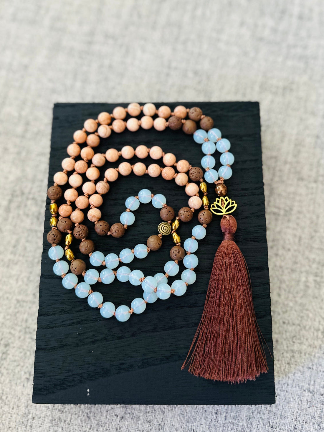 Elegant Transformation Mala with Opalite, Peach Moonstone, Lava, and Hematite, designed for meditation and emotional clarity