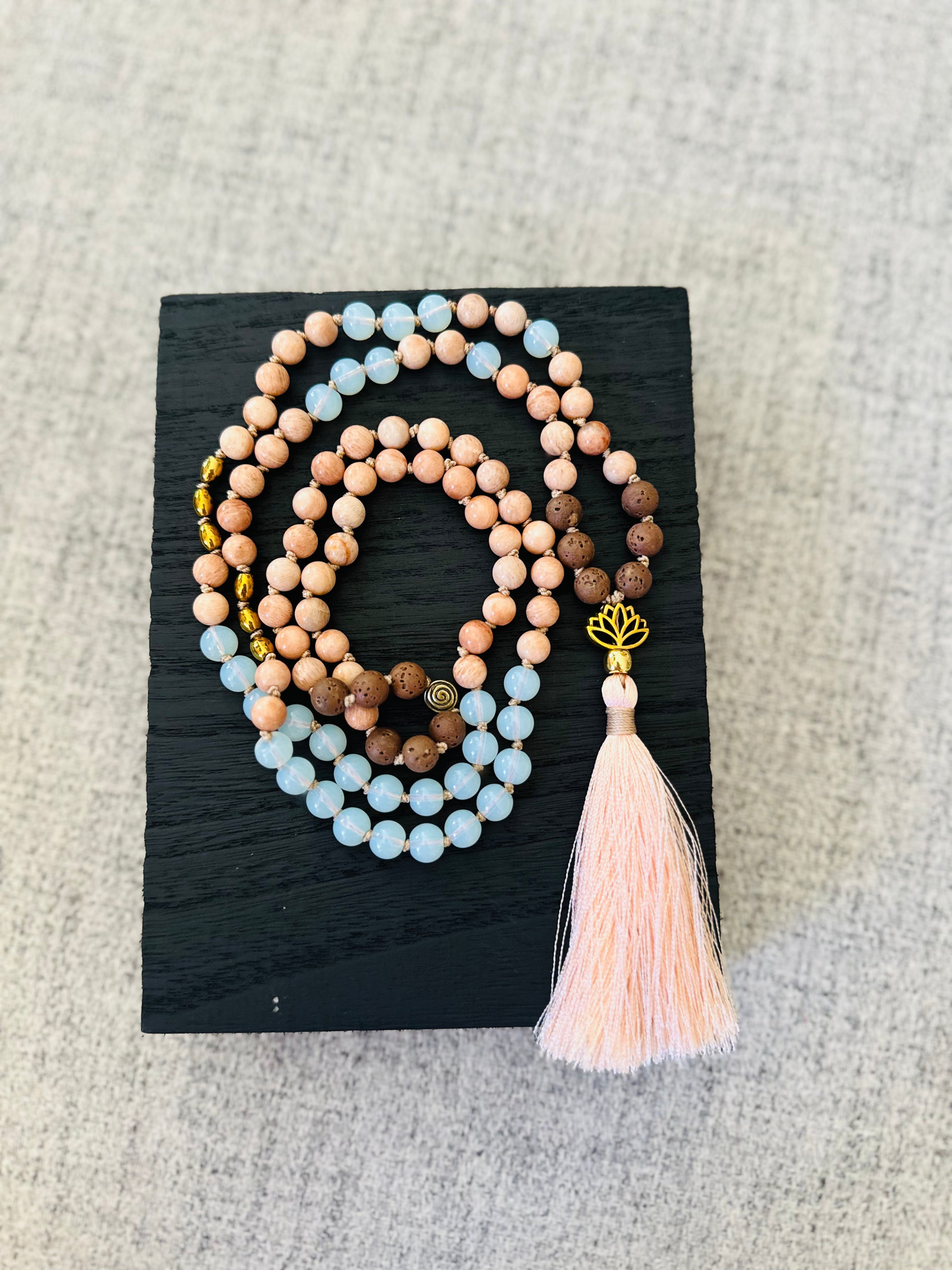 Lava, Opalite, Peach Moonstone, and Hematite stones in the Spirit of Balance Mala offer grounding, healing, and transformation