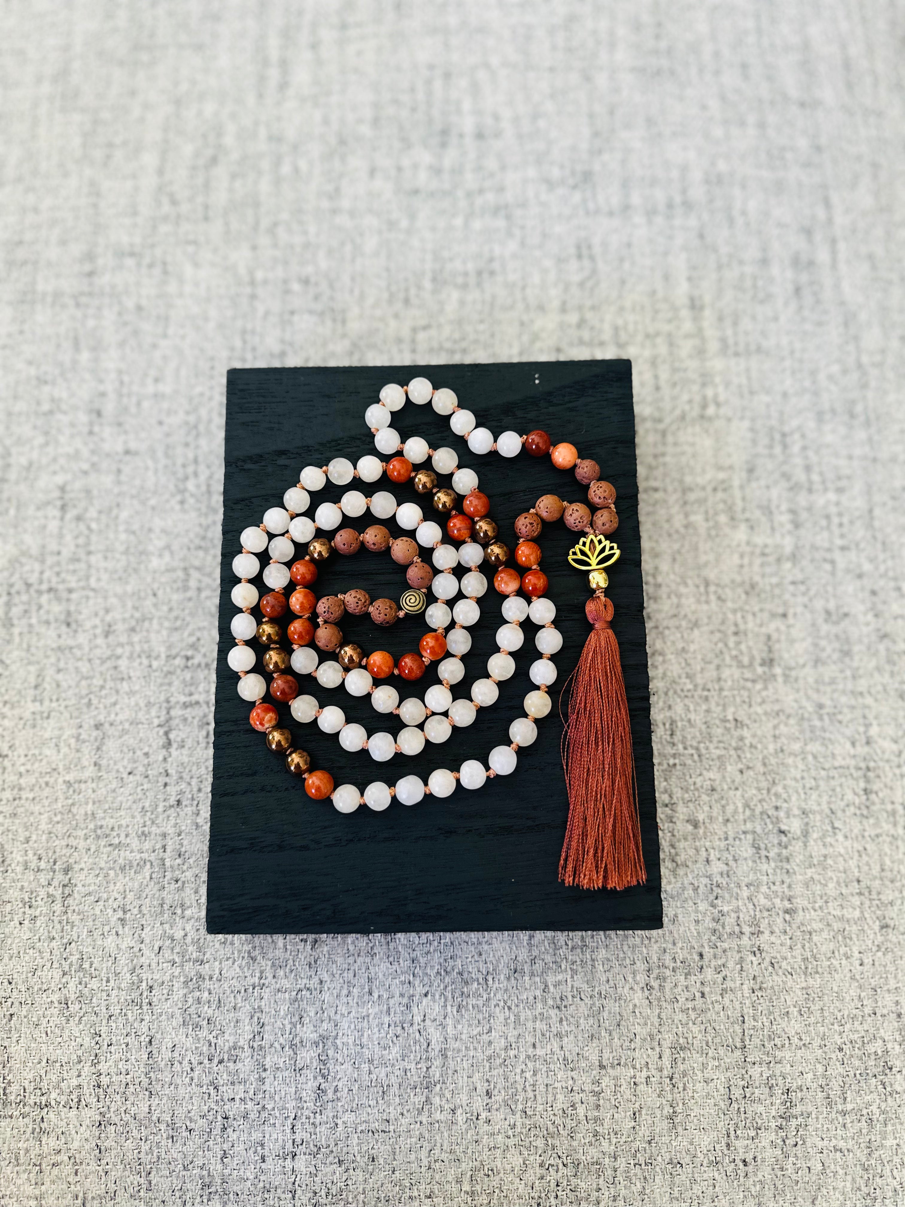 A bold combination of Red Jasper, White Jade, and Lava stones, beautifully packaged for meditation and daily wear