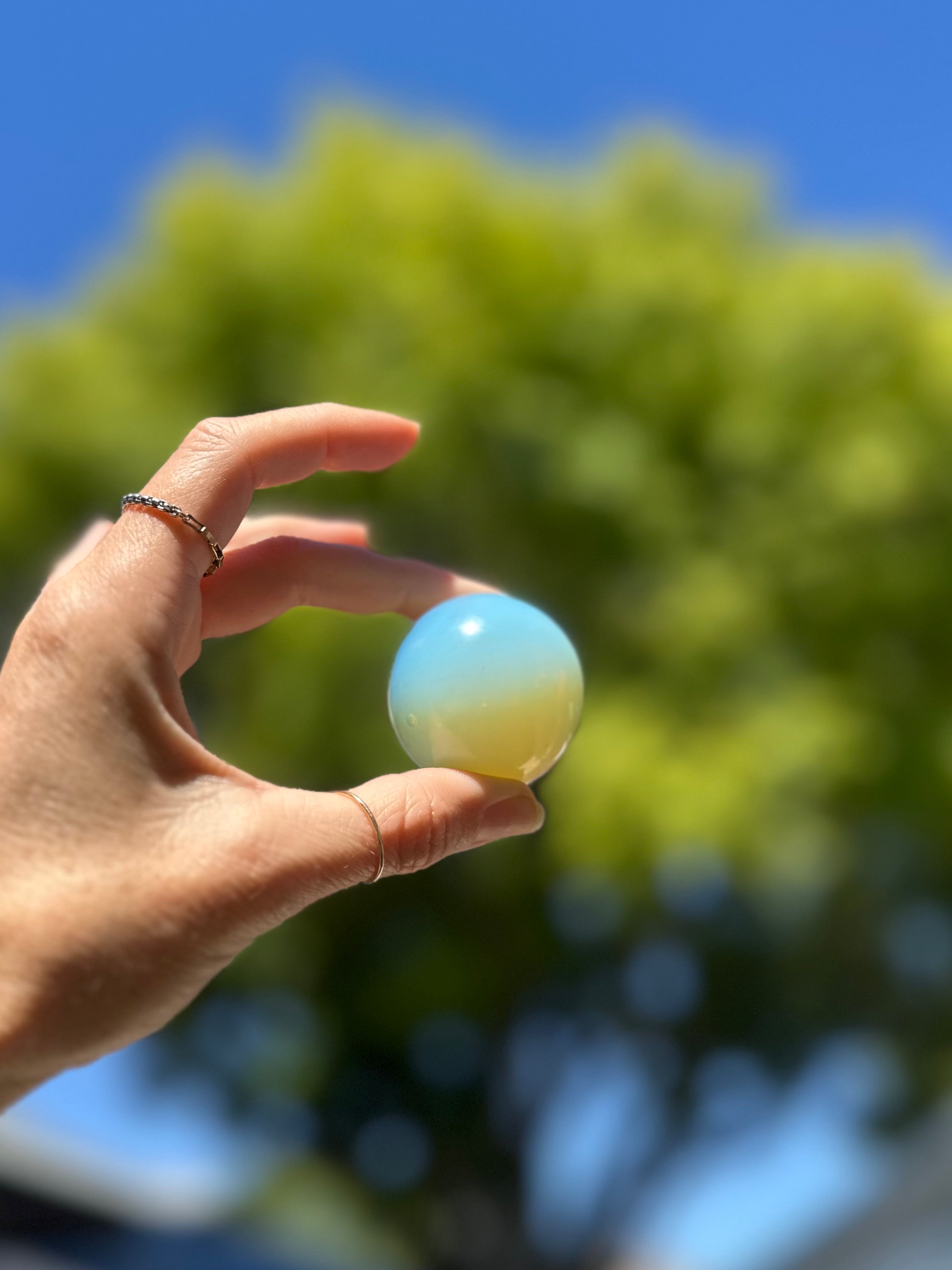 Opalite Sphere, perfect for meditation or display, amplifies soothing energy in all directions, promoting positivity and serenity.