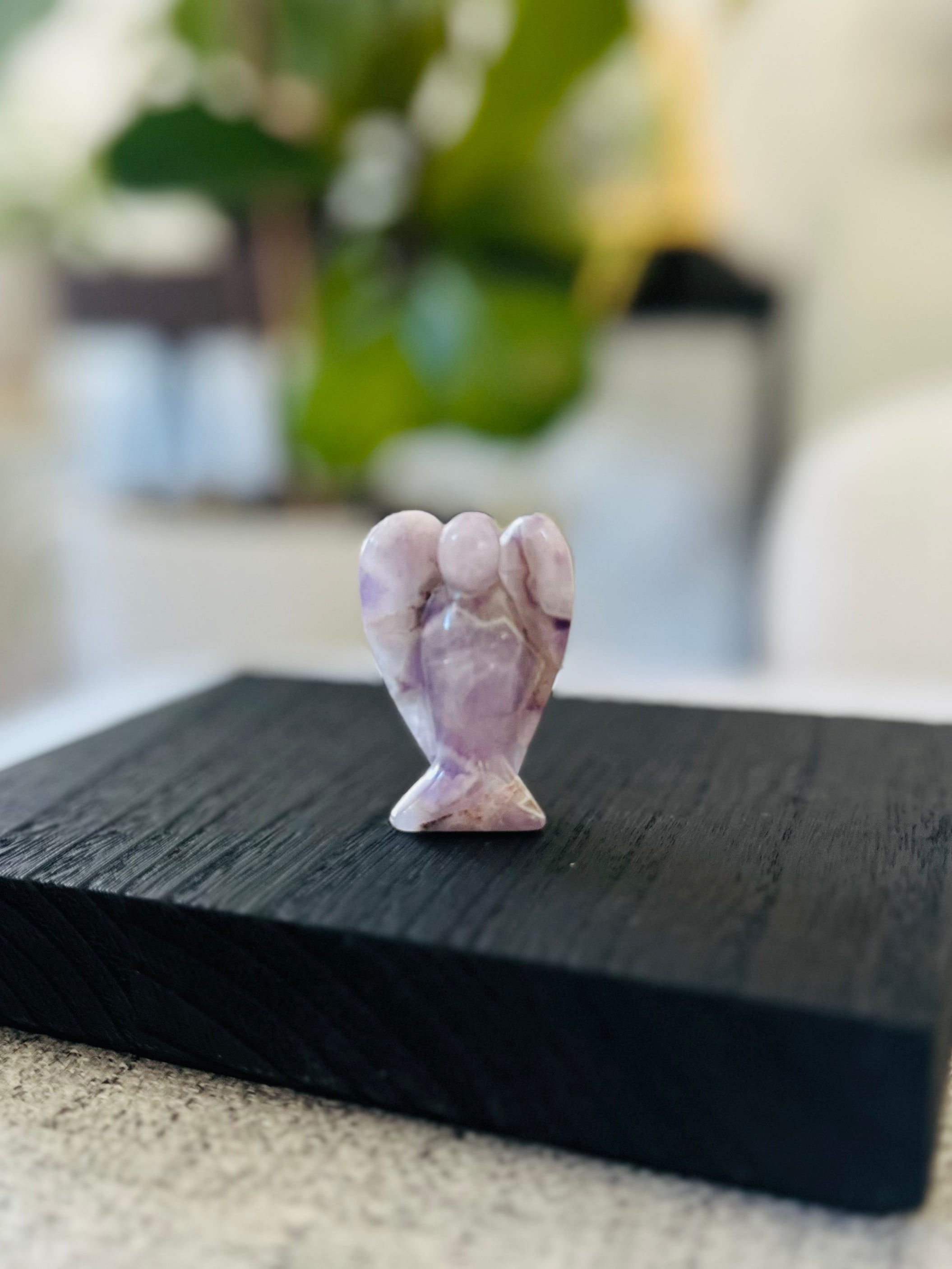 Purple Lepidolite angel figurine reducing stress and anxiety, providing emotional balance and inner peace.