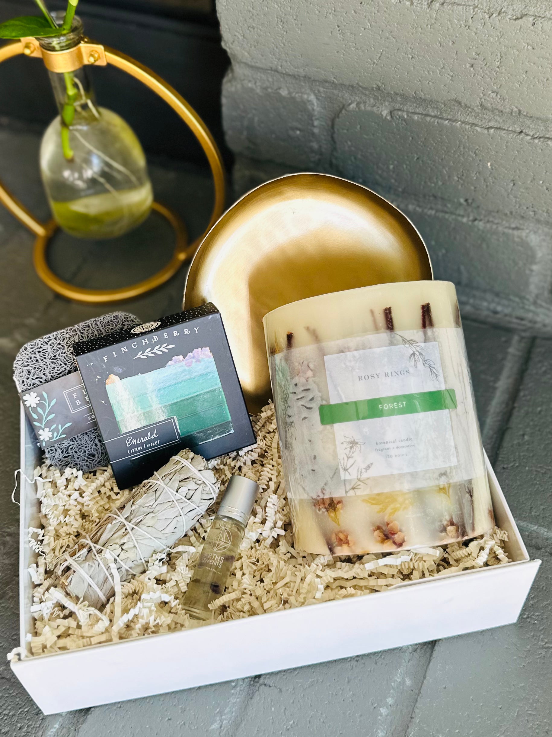 emerald forest gift box with fluorite-infused essential oil, sage bundle, vegan soap, soap saver, and gold plate dish for tranquility