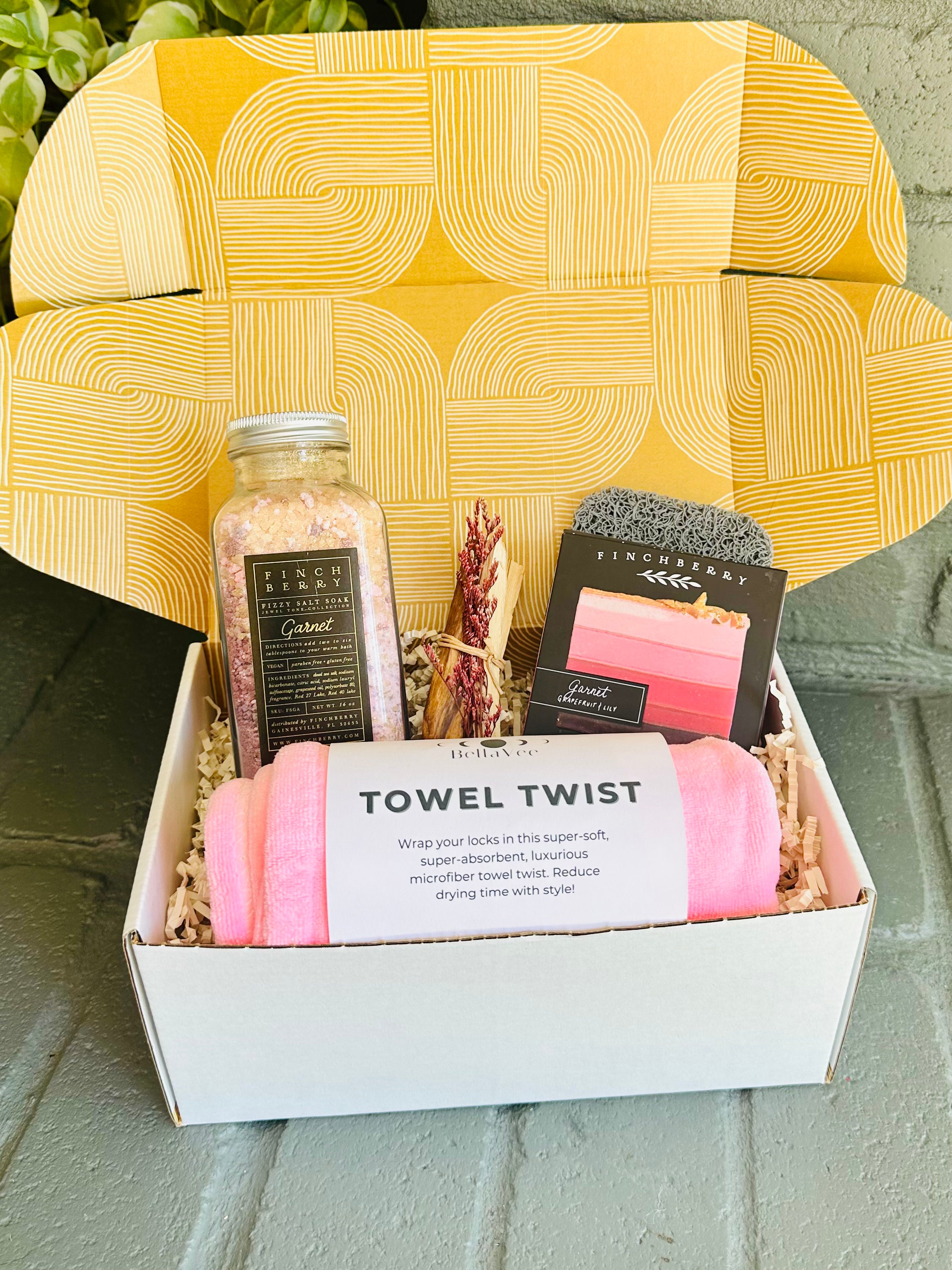 garnet glow gift box with luxury bath essentials, including towel twist, soap, bath fizzies, and palo santo, beautifully packaged for gifting