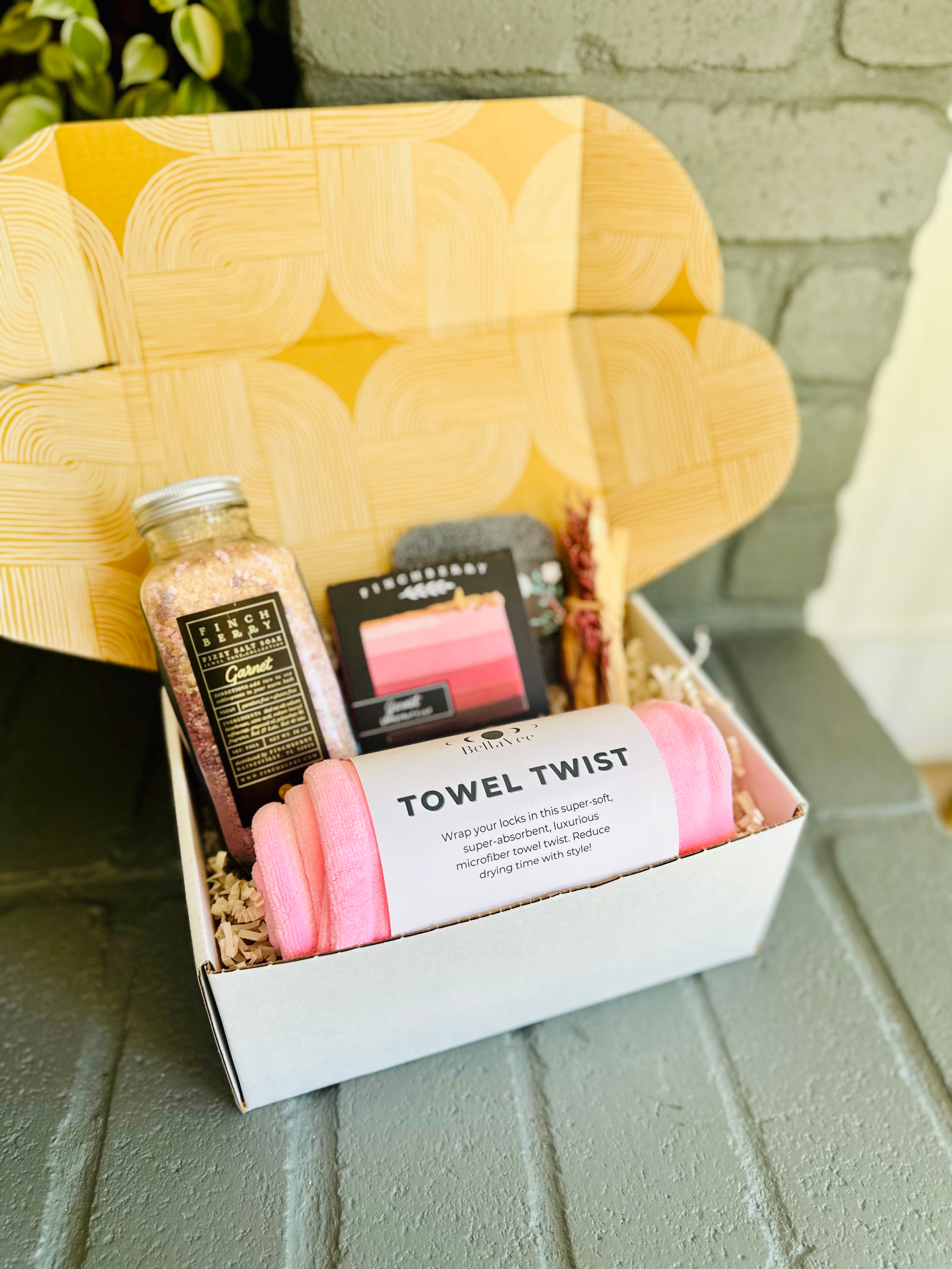 pamper yourself with the garnet glow gift box, featuring garnet bath fizzies, luxury soap, pink towel twist, and palo santo for serenity