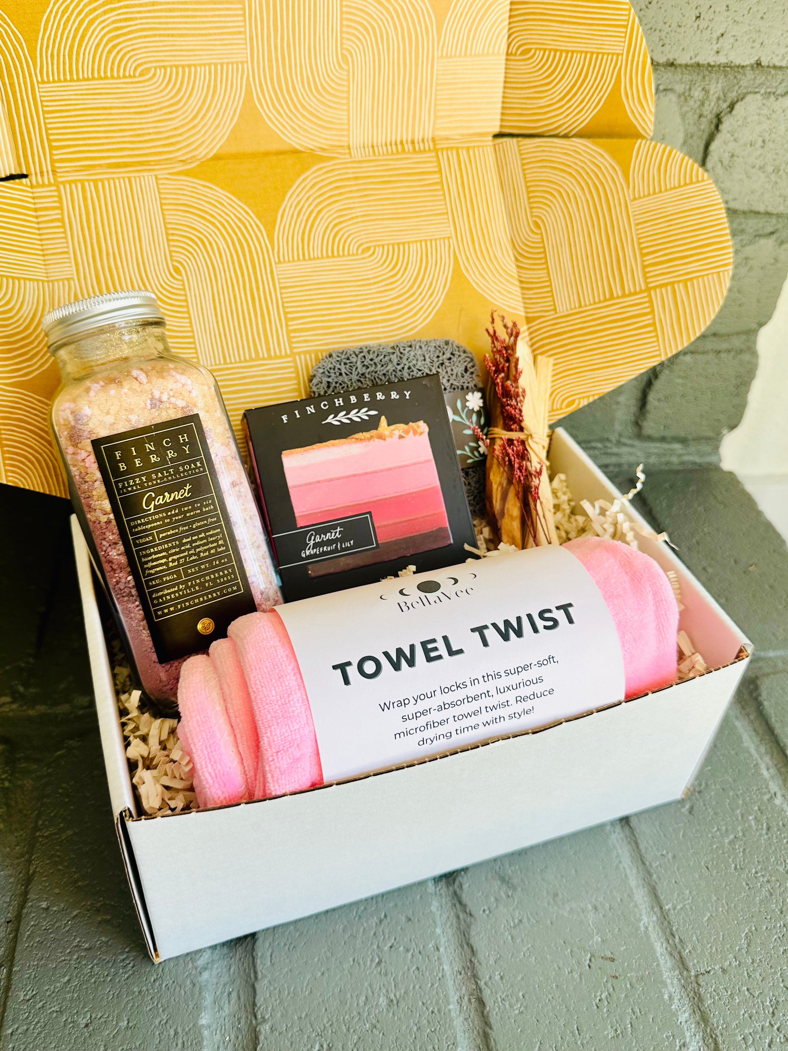 garnet glow gift set with bath fizzies, luxury soap, soap saver, pink towel twist, and palo santo bundle, perfect for relaxation and gifting