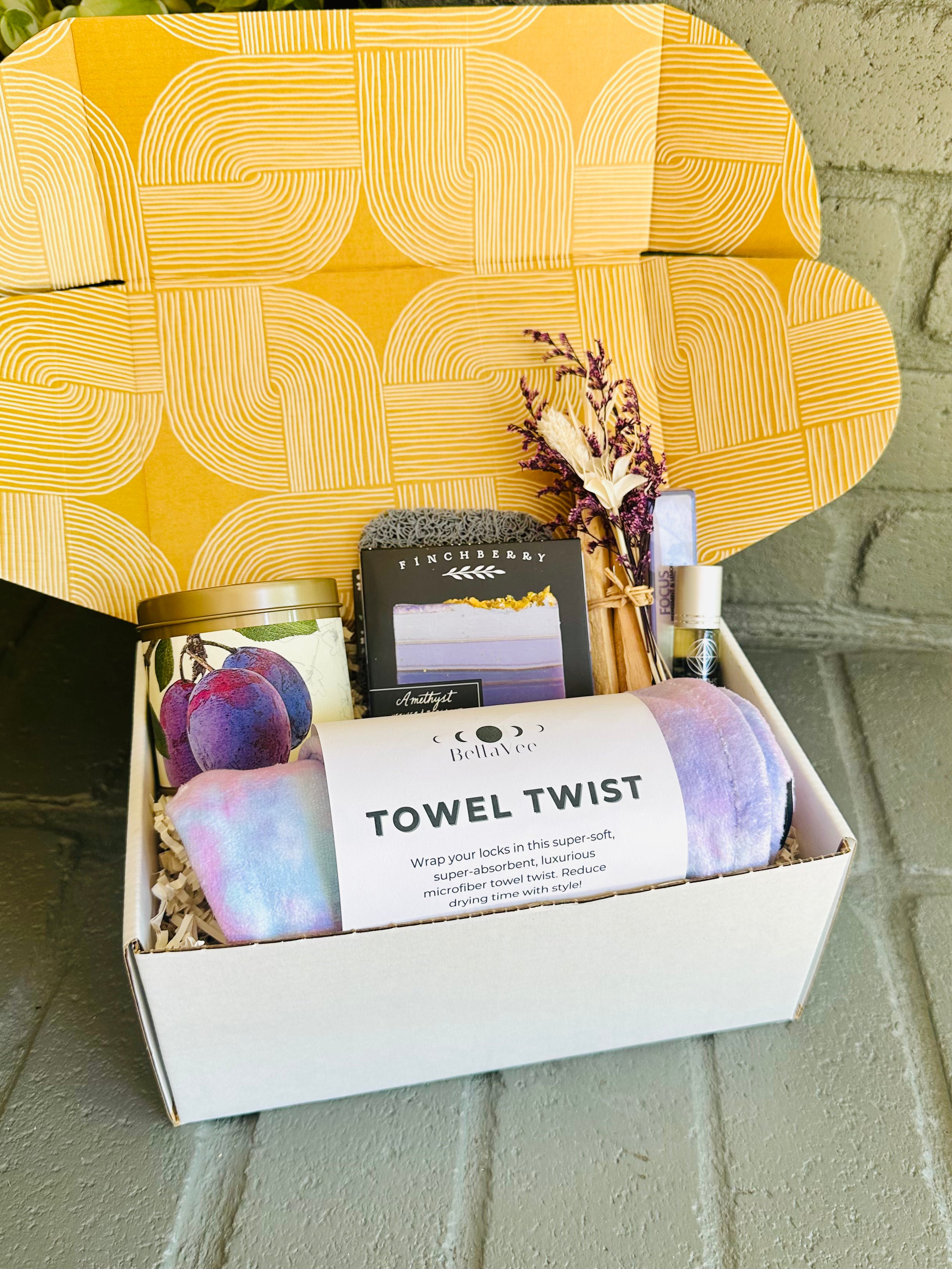 Indulge in the Purple Bliss Gift Box, featuring a luxurious towel twist, Amethyst soap, and Wild Plum candle for ultimate serenity