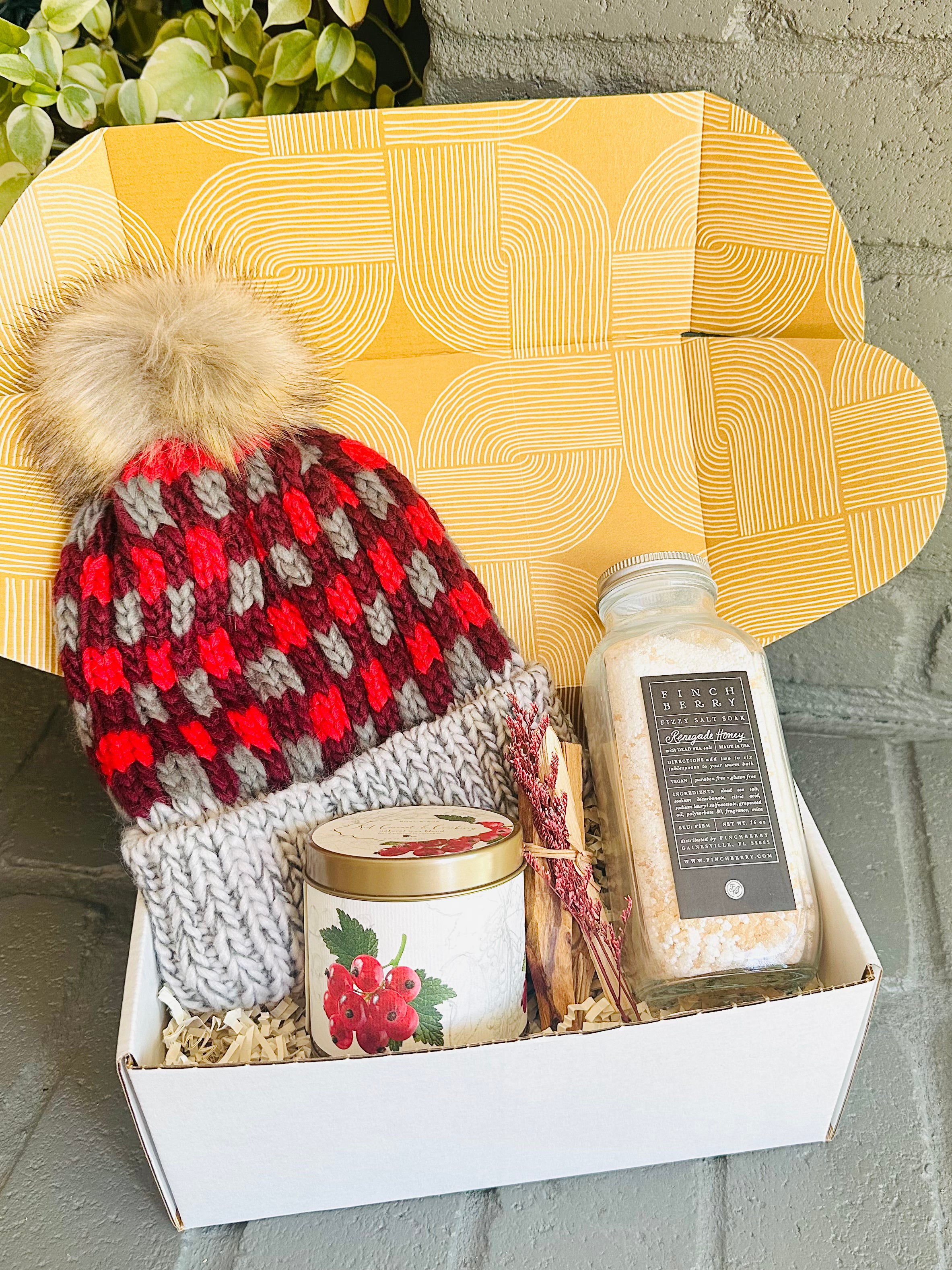 Holiday Cheer Gift Box with bath fizzies, Palo Santo, red currant candle, and plaid beanie for a cozy holiday season