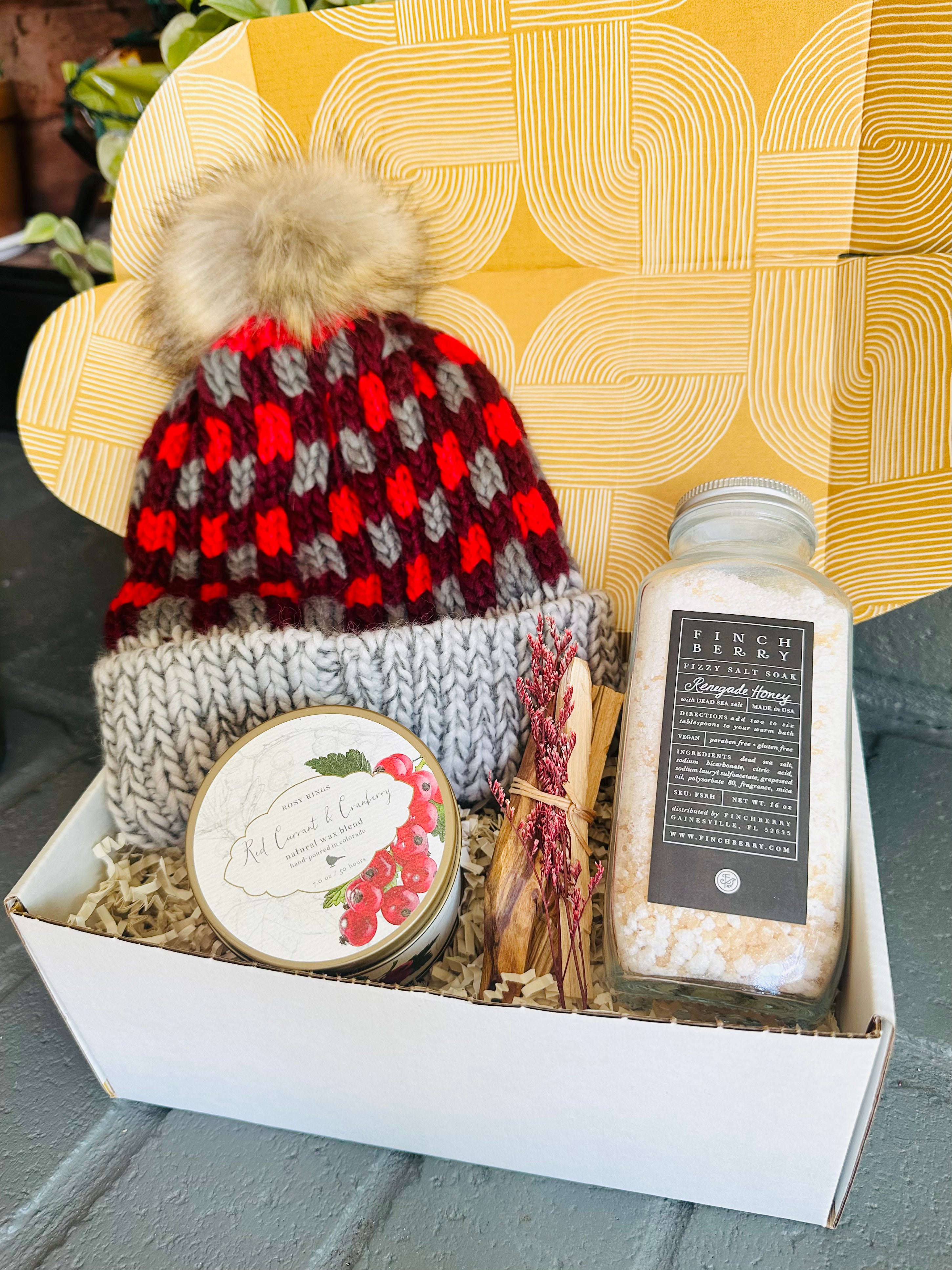 Holiday Cheer Gift Box featuring bath fizzies, seasonal candle, Palo Santo, and a plaid beanie to keep you warm and festive