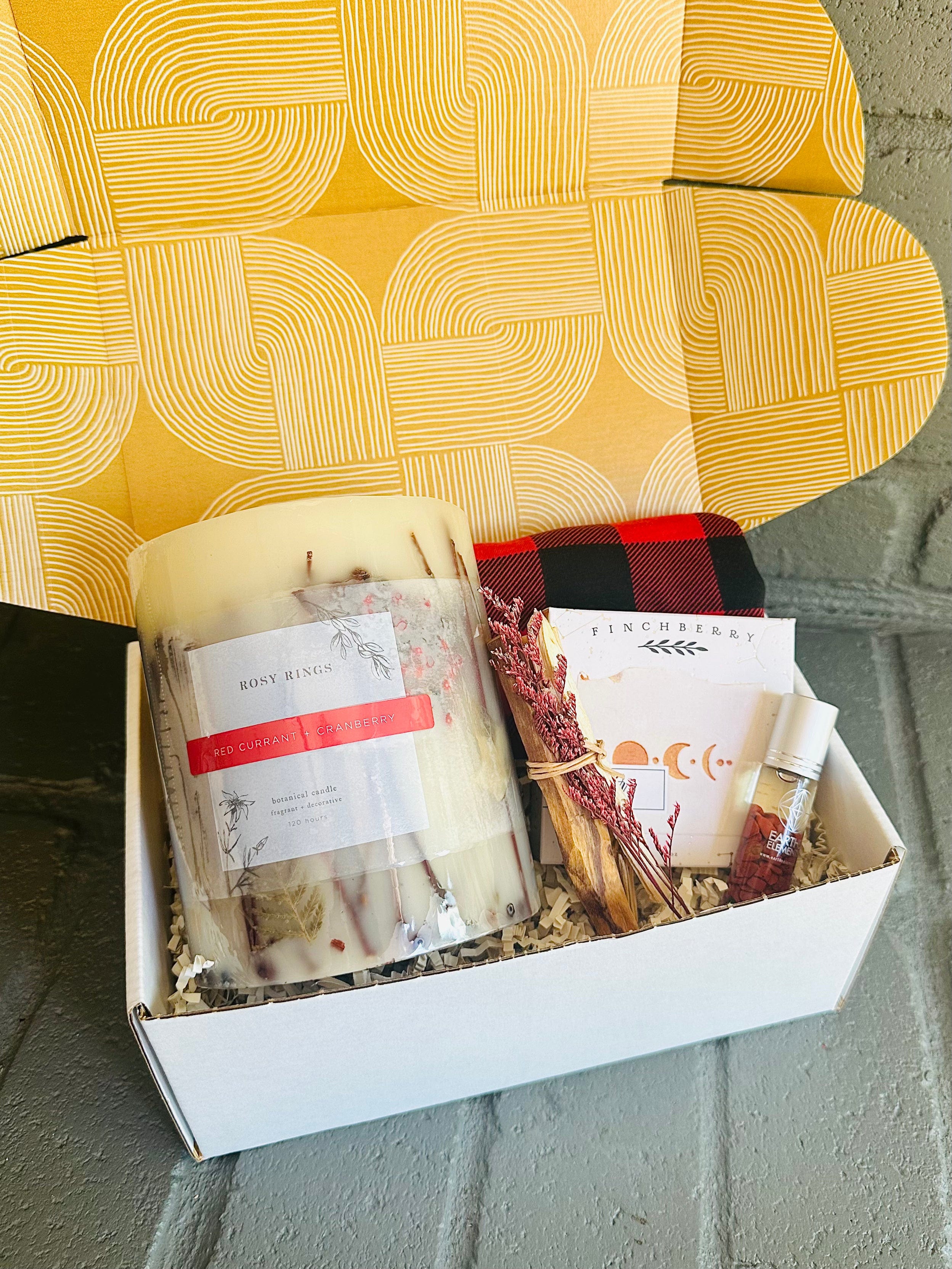 Wrap yourself in serenity with the Winter Warmth Gift Box, featuring a luxurious candle, body soap, and plaid beanie