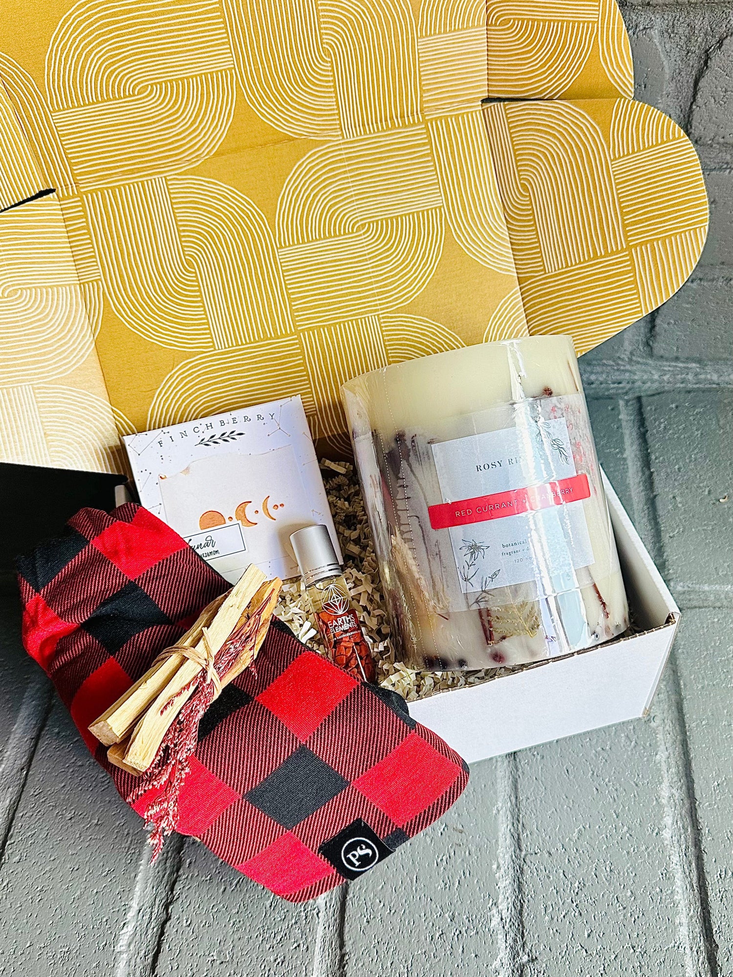 Winter Warmth Gift Box – indulge in holiday comfort with a red currant candle, Palo Santo, essential oil roll-on, and more