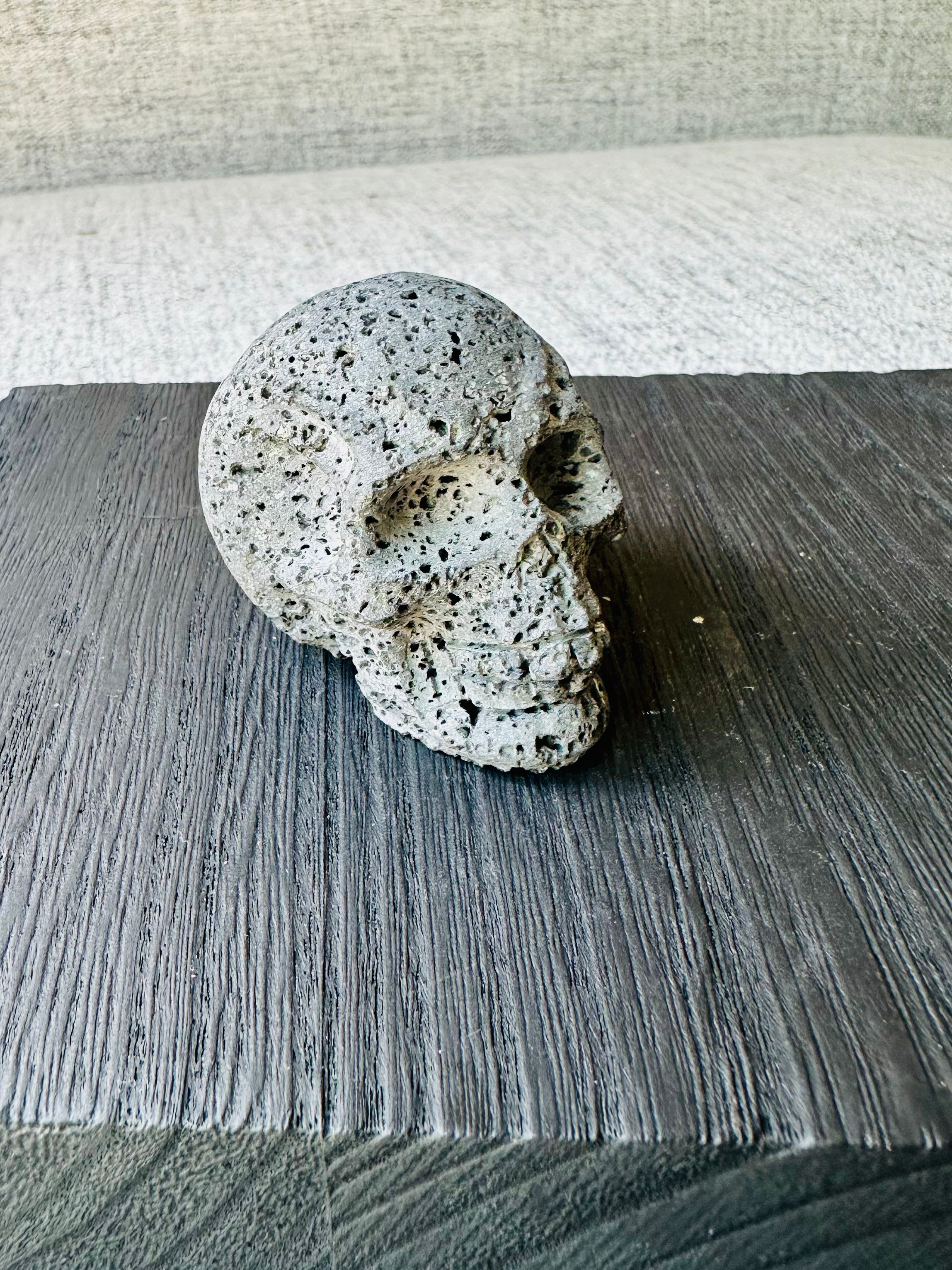 Lava Stone Skull, shaped from volcanic stone, promotes grounding and protection, making it a striking symbol of transformation and resilience