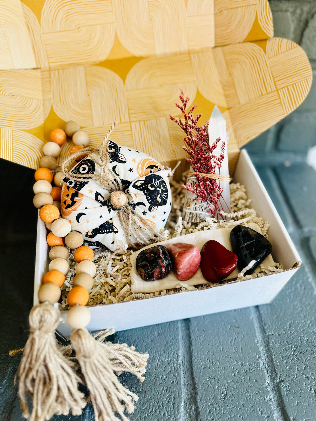 Halloween-inspired Spooky Vibes Gift Box features White Sage, Selenite wand, tumbled stones, and fall-themed decor, perfect for autumn rituals