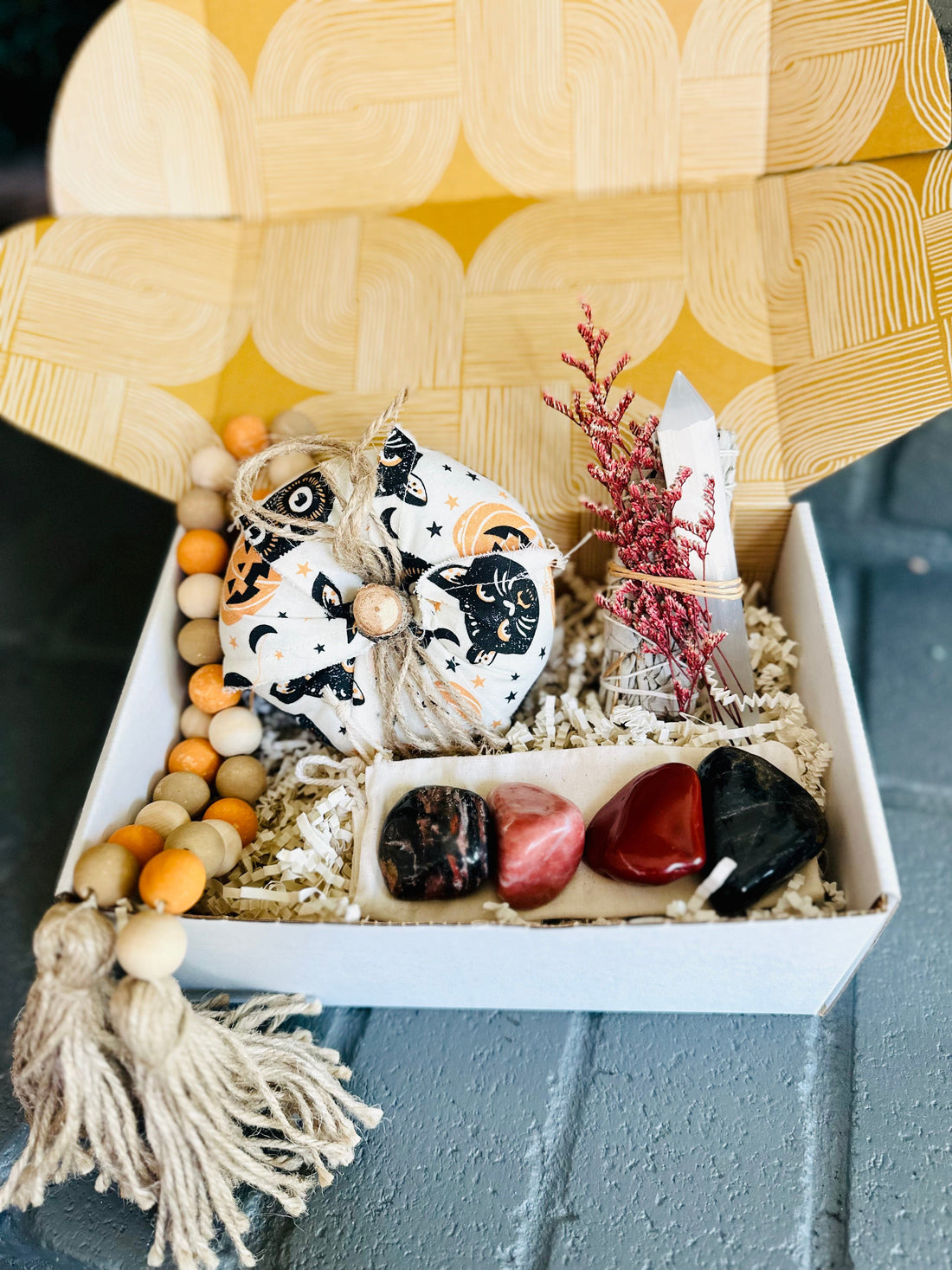 Spooky Vibes Gift Box with a cozy cotton pumpkin, White Sage bundle, Selenite wand, wooden bead decor, and grounding tumbled stones