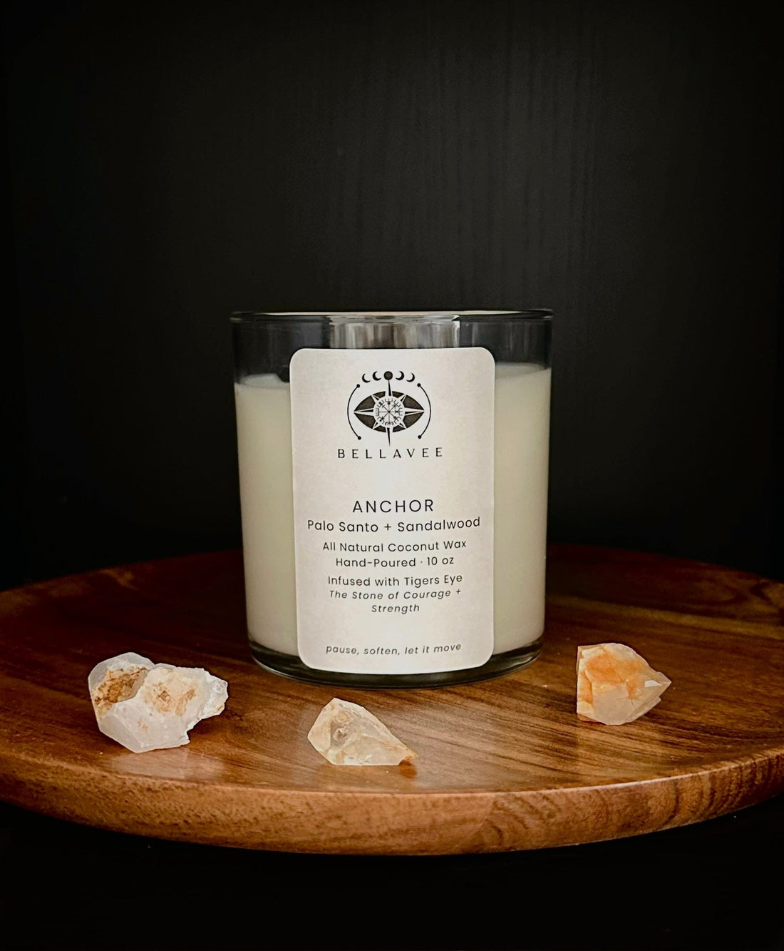Anchor grounding ritual candle infused with tiger’s eye crystal, hand-poured coconut wax candle displayed on wood with dark, earthy tones.