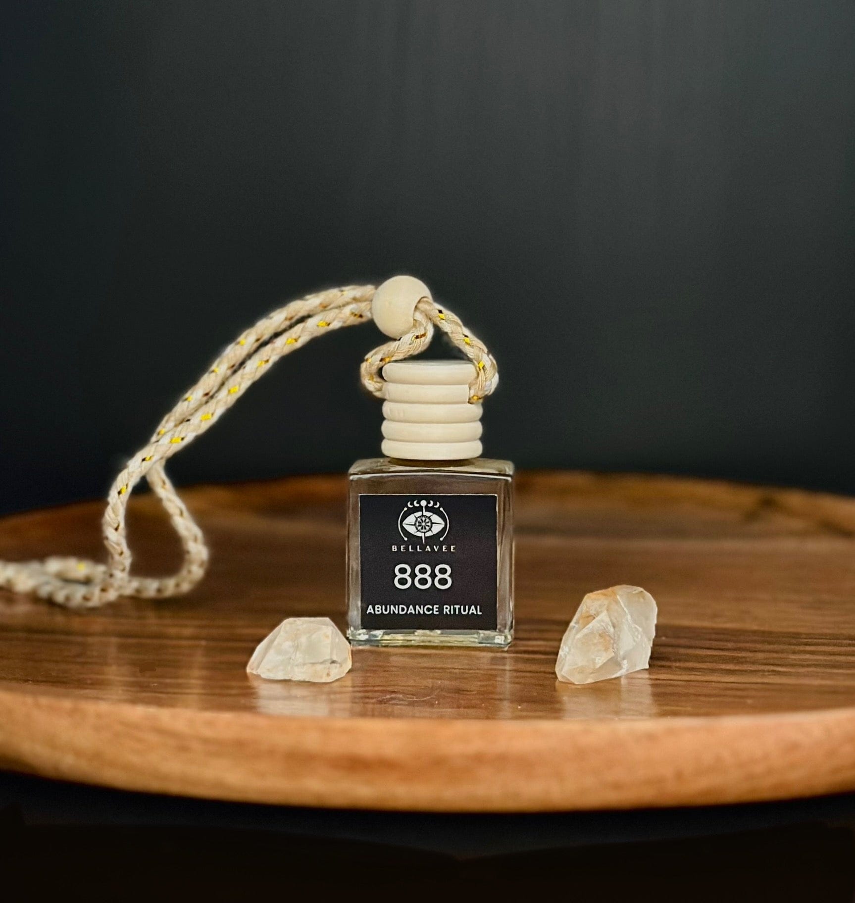 Crystal-infused diffuser labeled “888” with Citrine stones on a wooden surface.