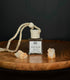 Crystal-infused diffuser labeled “Anchor” with Tiger’s Eye stones on a wooden surface.