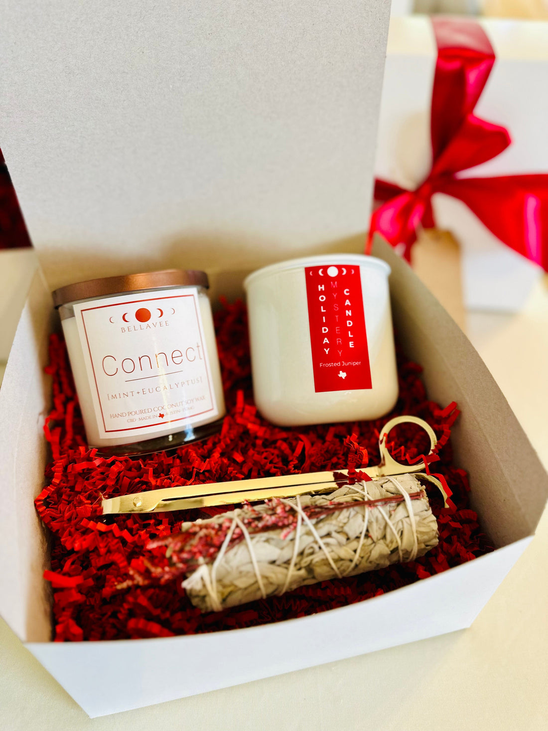Ultimate Gift Box featuring CBD and holiday candles, sage bundle, and wick trimmer for self-care and relaxation.