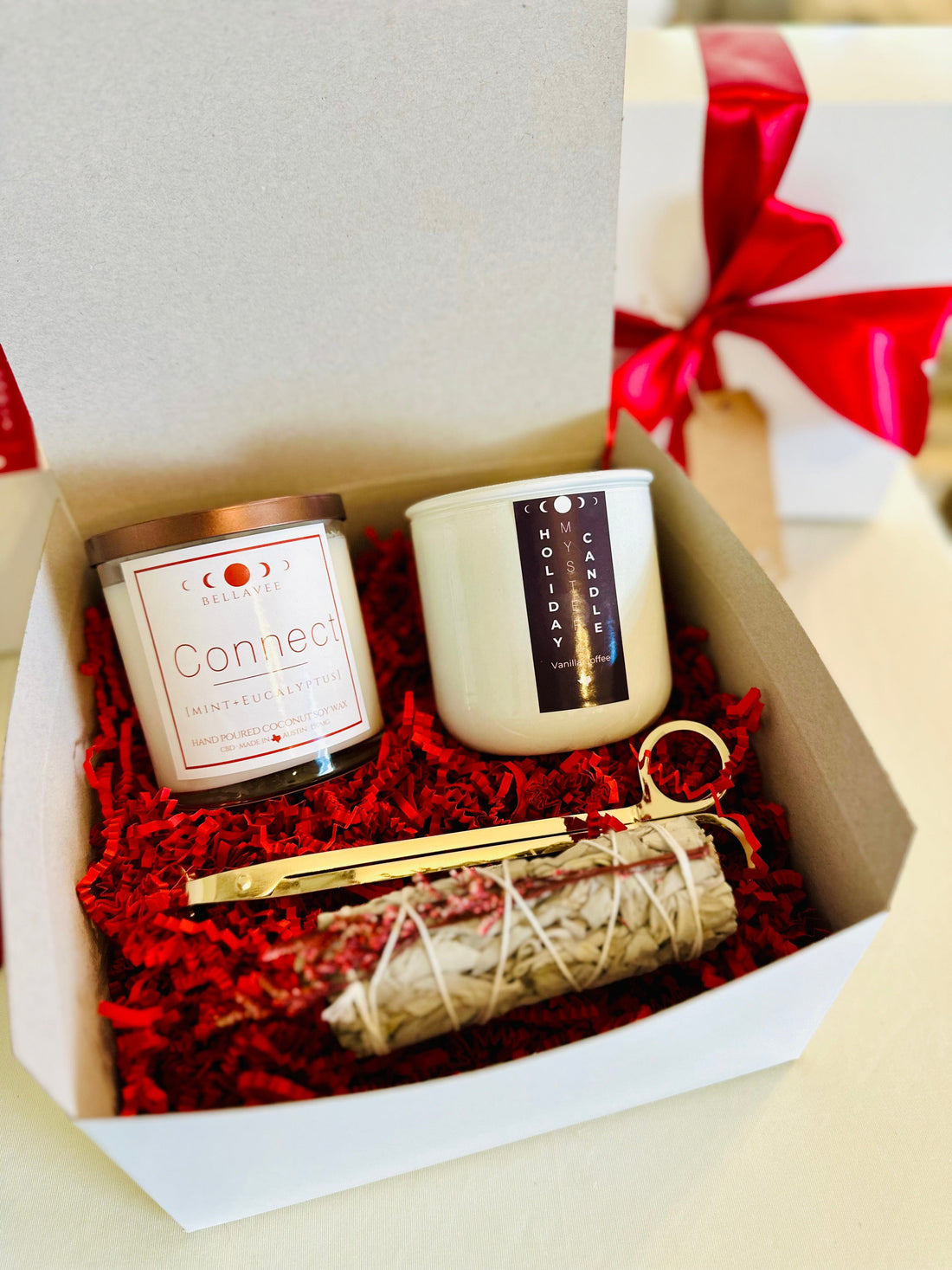 Luxurious self-care gift set with aromatherapy candles, sage smudge stick, and candle wick trimmer.