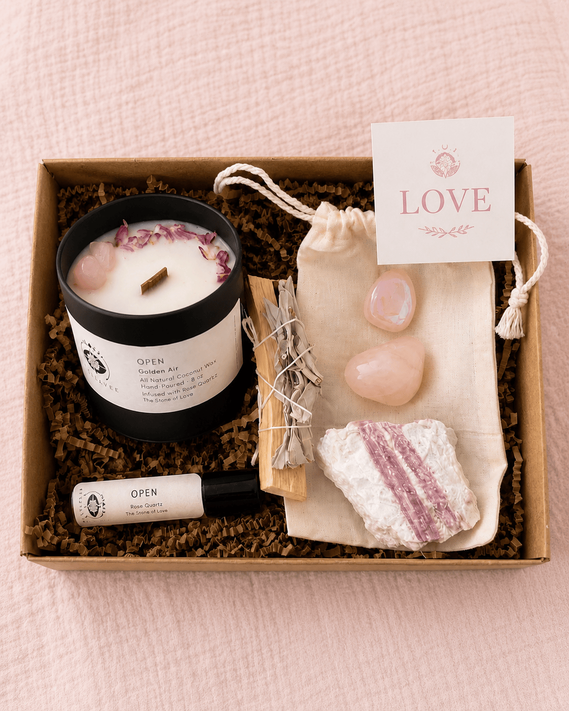 BellaVee Full Size Love Ritual Kit featuring an OPEN crystal candle, perfume oil, Rose Quartz, Pink Tourmaline, Palo Santo, White Sage, and a ritual card in a kraft gift box.