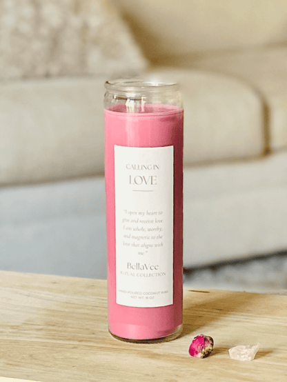 Love Ritual Candle with soft pink wax in a clear glass vessel, styled on a wooden table