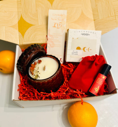 Lunar New Year Year of the Snake Gift Box with Snake Candle, Clary Sage Essential Oil Roll-On, and 2025 Crystal Bookmark in a red velvet bag.
