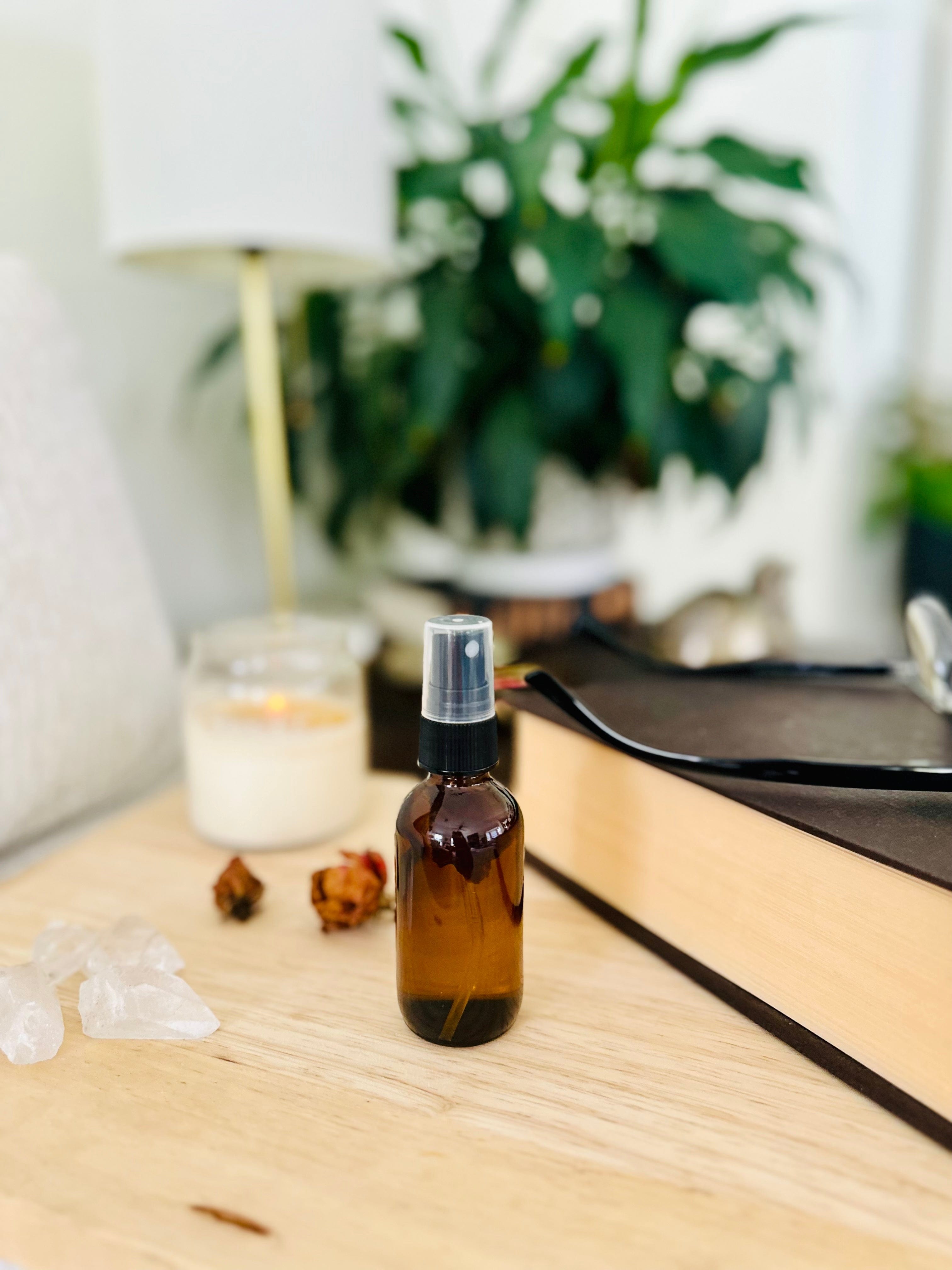 Home setting with Flower Moon Mist with books, full moon ritual tools, and stones