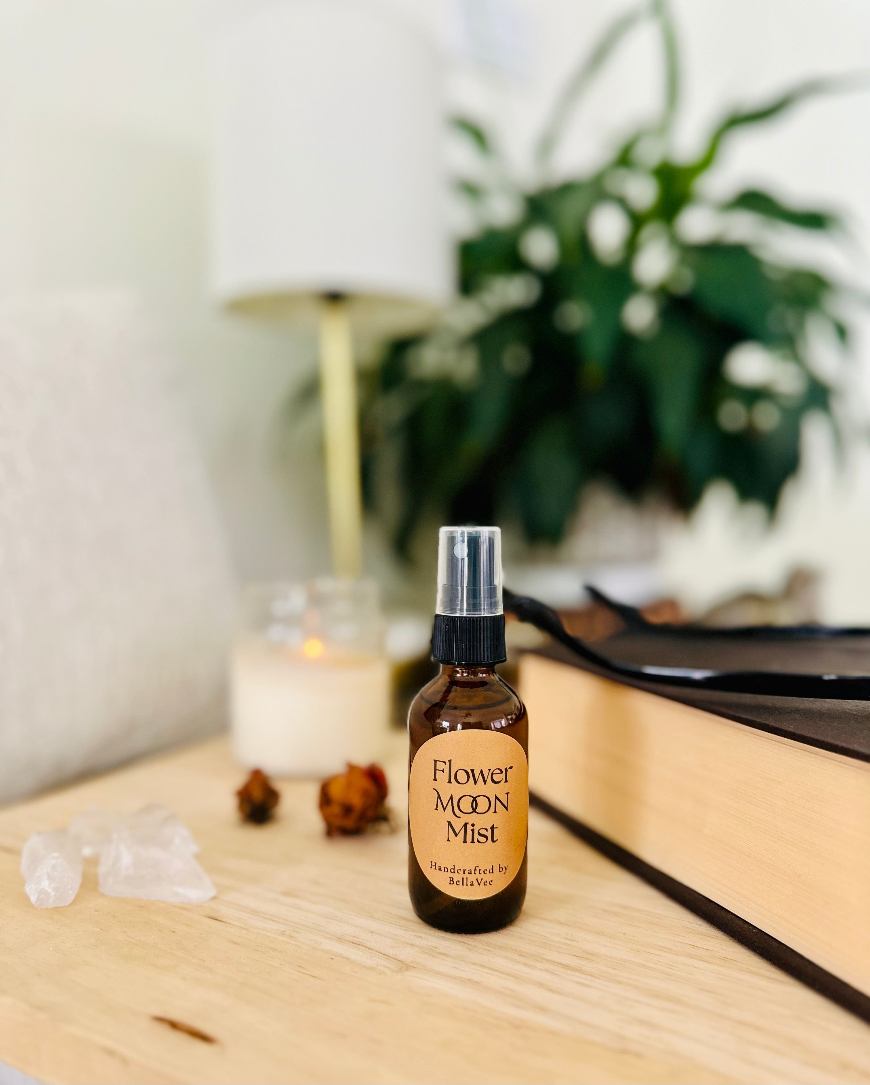 2 oz amber glass bottle labeled Flower Moon Mist surrounded by dried botanicals