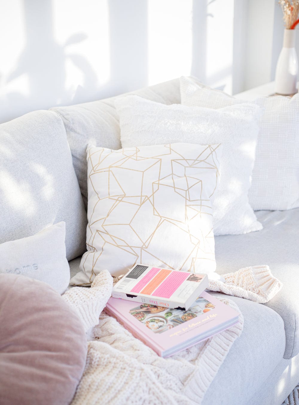 cozy-couch-with-a-blanket-and-books