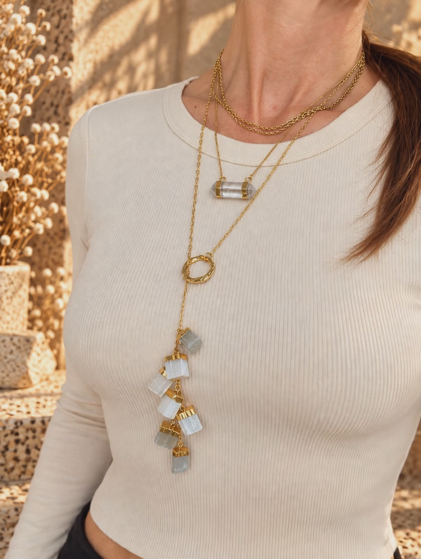 Seven-stone Selenite pull-through necklace worn showing movable gold ring and cascading crystal drop