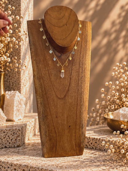 Rutilated Quartz point necklace worn showing delicate medallion details and adjustable gold chain