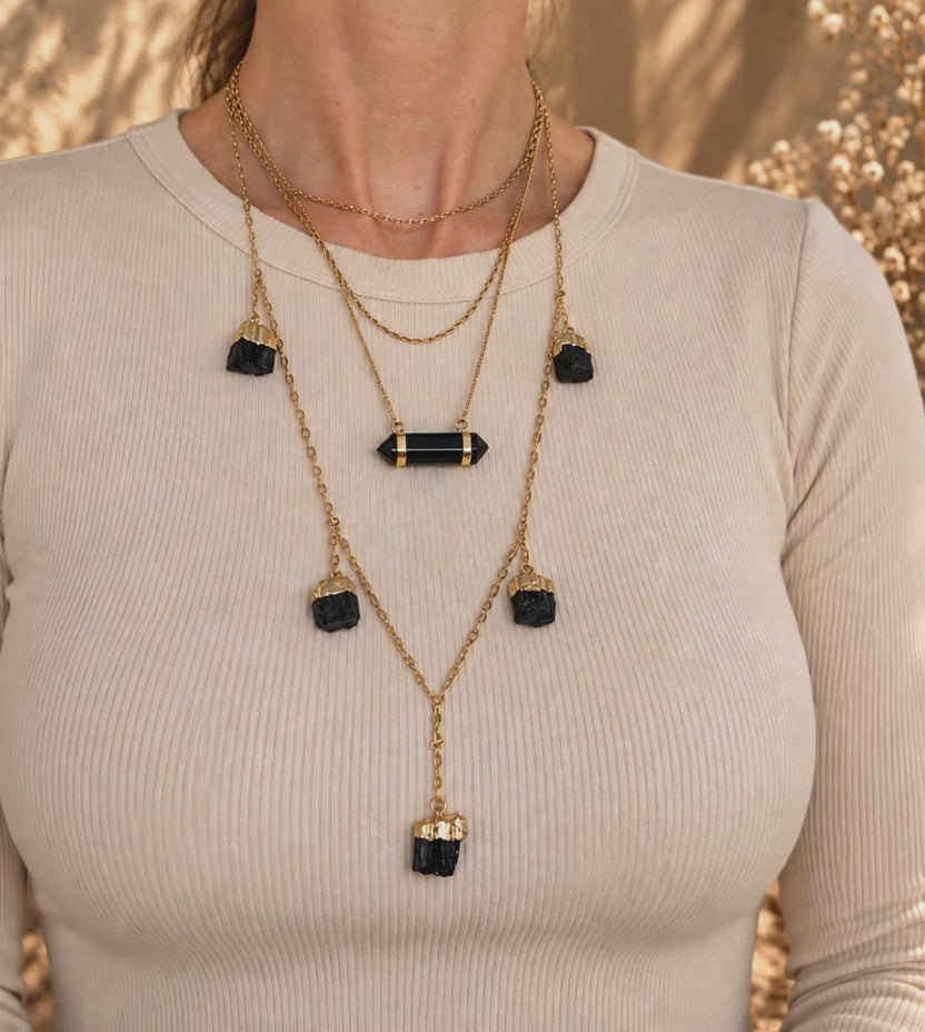 Black Tourmaline V-drop necklace worn and layered showing adjustable gold chain and natural stones
