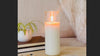 Woman lighting a BellaVee amethyst ritual candle