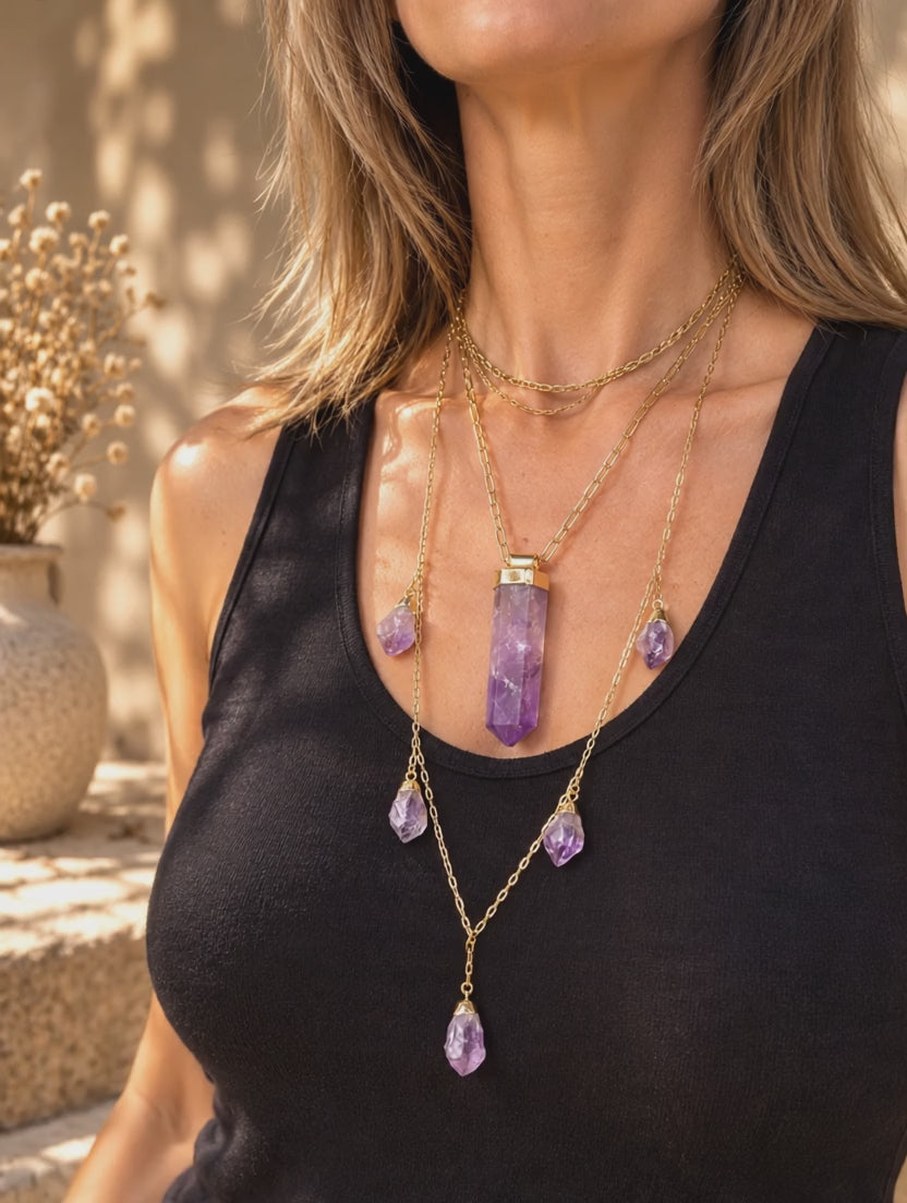 Large Amethyst crystal pendant necklace worn and styled in a layered jewelry stack to show its adjustable length