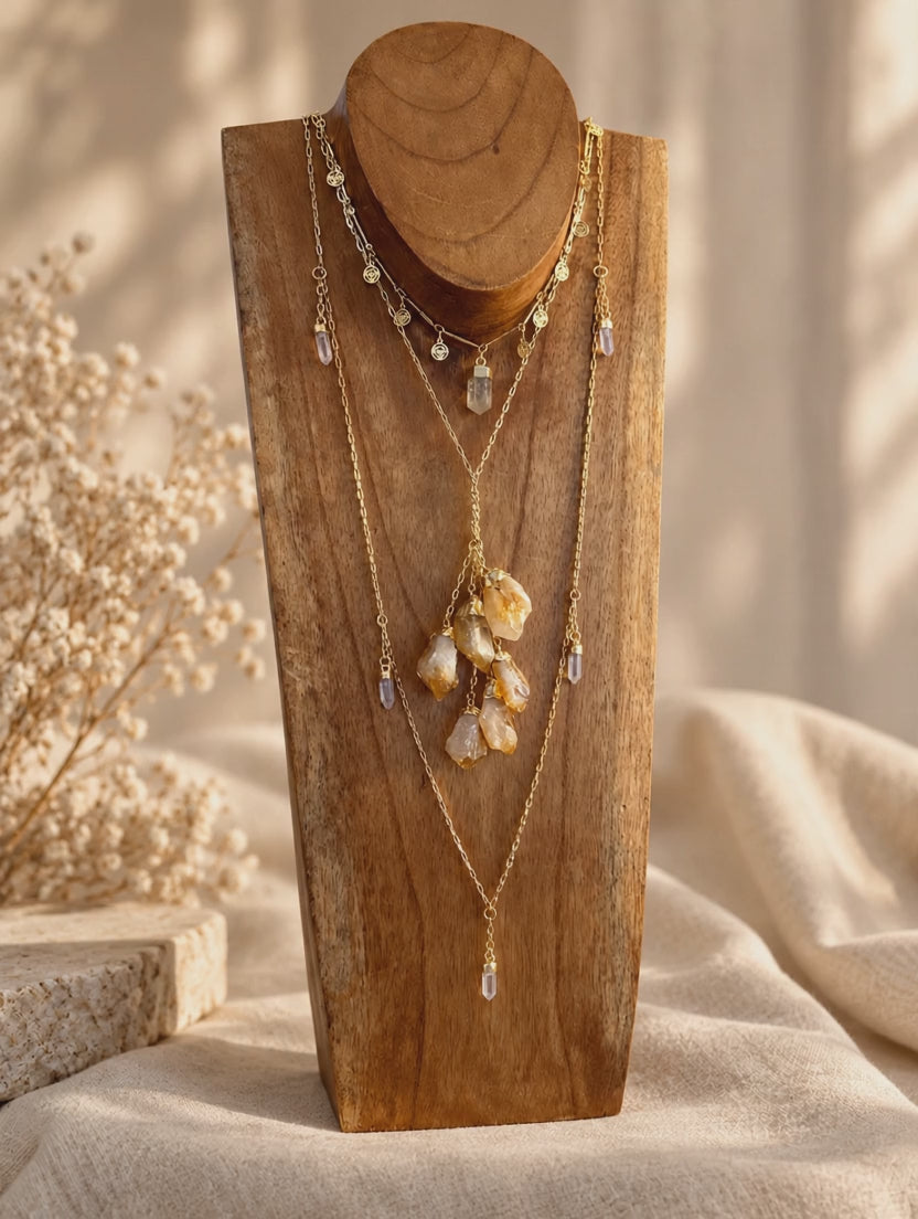 Citrine six-stone cluster drop necklace worn and styled with layered crystal jewelry