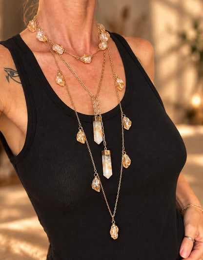 Two-stone crystal lariat necklace worn in a layered crystal necklace stack