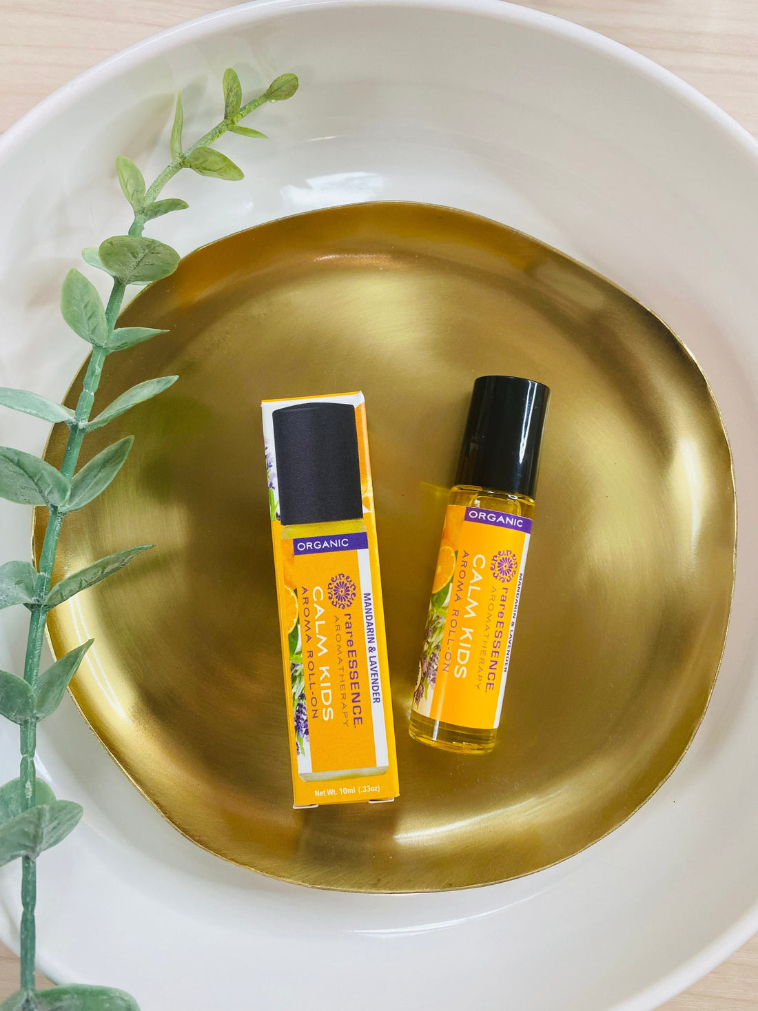 Organic CALM KIDS Aromatherapy Roll-On, formulated with pure essential oils like Jojoba, Tangerine, and Mandarin, promotes relaxation and calmness for kids.