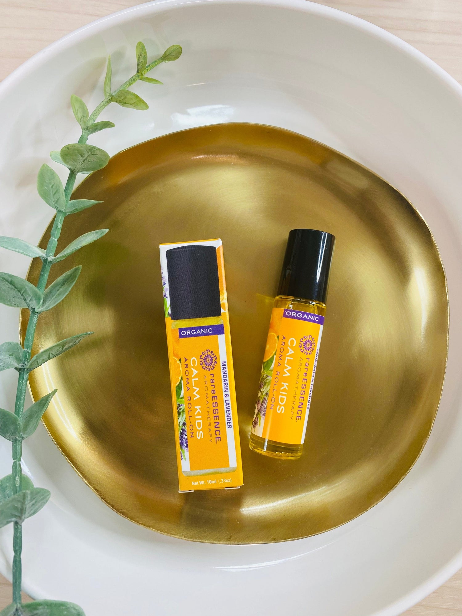 Organic CALM KIDS Aromatherapy Roll-On, formulated with pure essential oils like Jojoba, Tangerine, and Mandarin, promotes relaxation and calmness for kids.