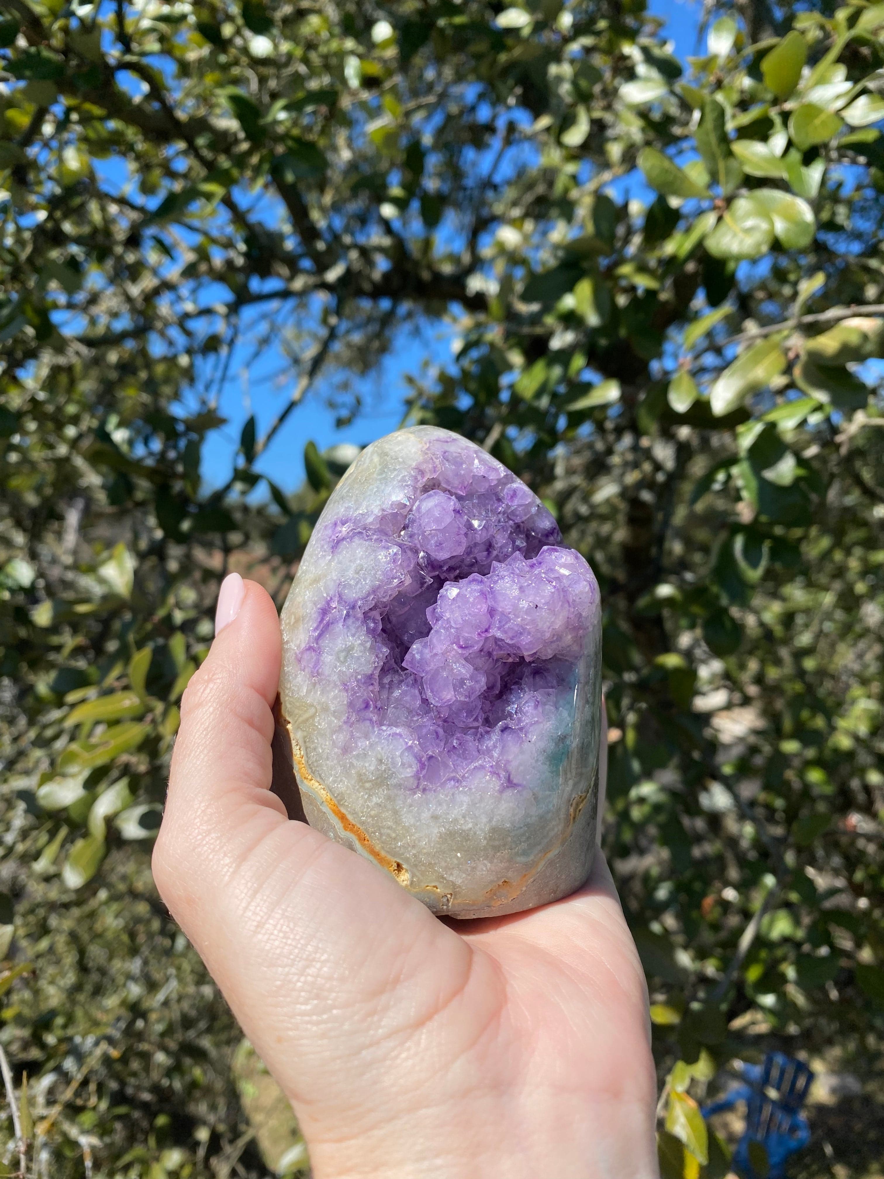 Lavender Amethyst and Quartz crystals with Brazilian Agate banding, glowing in the sunlight.