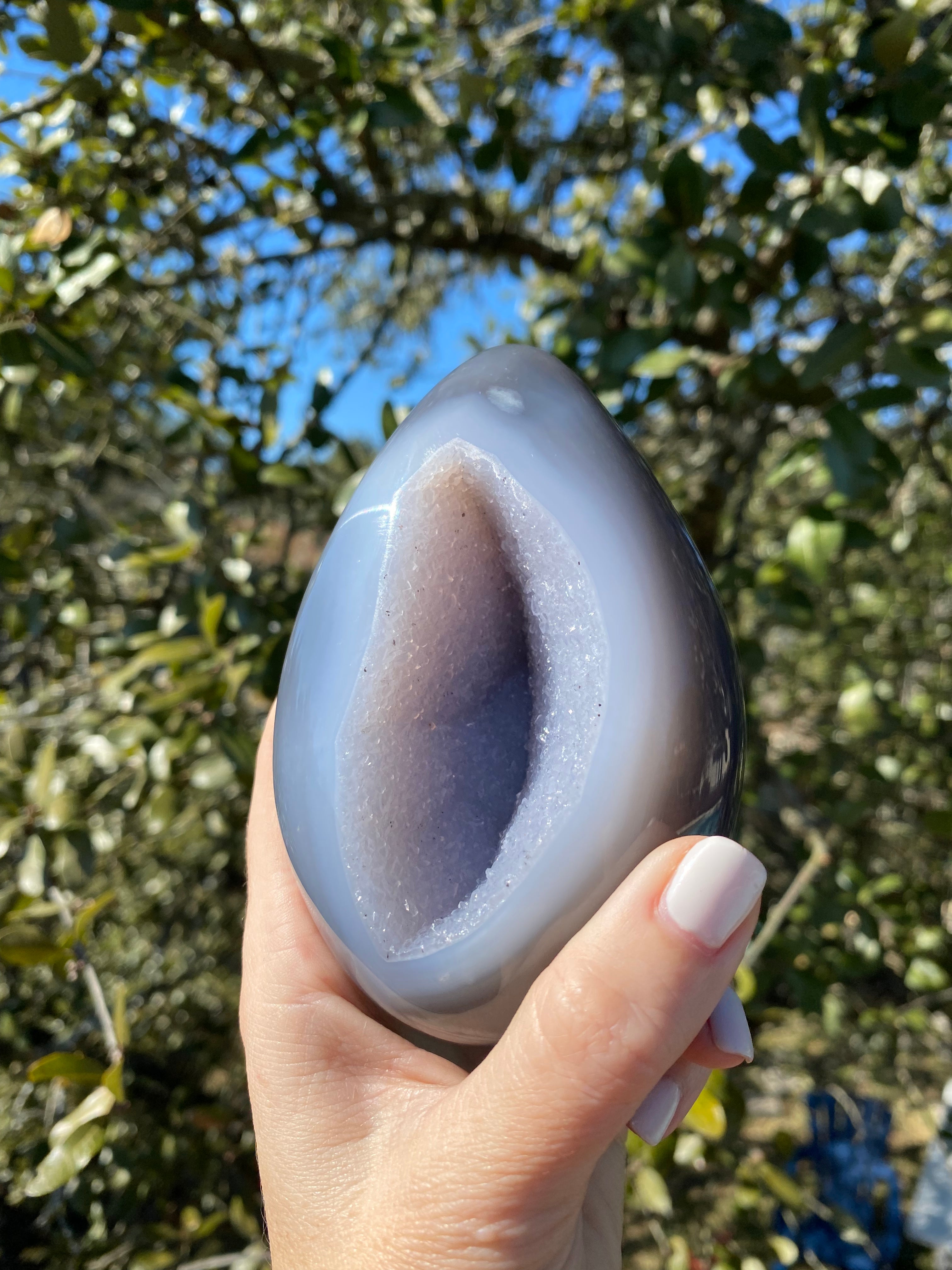 Striking egg-shaped Amethyst Geode, blue Agate exterior with lavender crystals, ideal for decor or collections